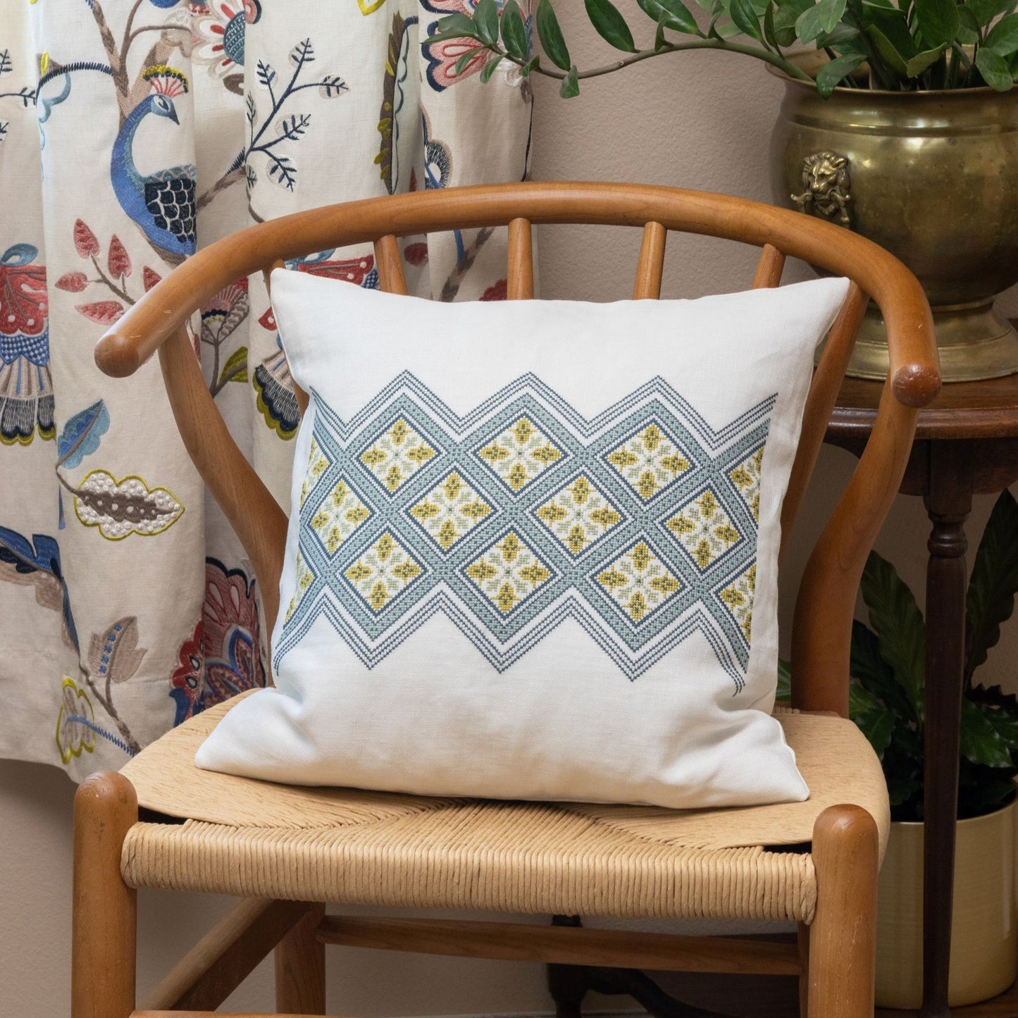 folk embroidery cushion with diamond design in blue