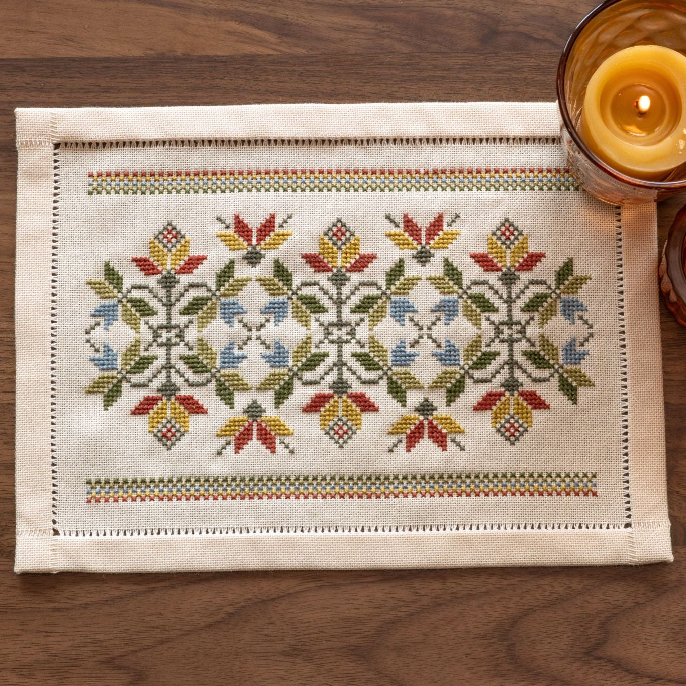 folk embroidery cross stitch table mat with leaves in fall palette