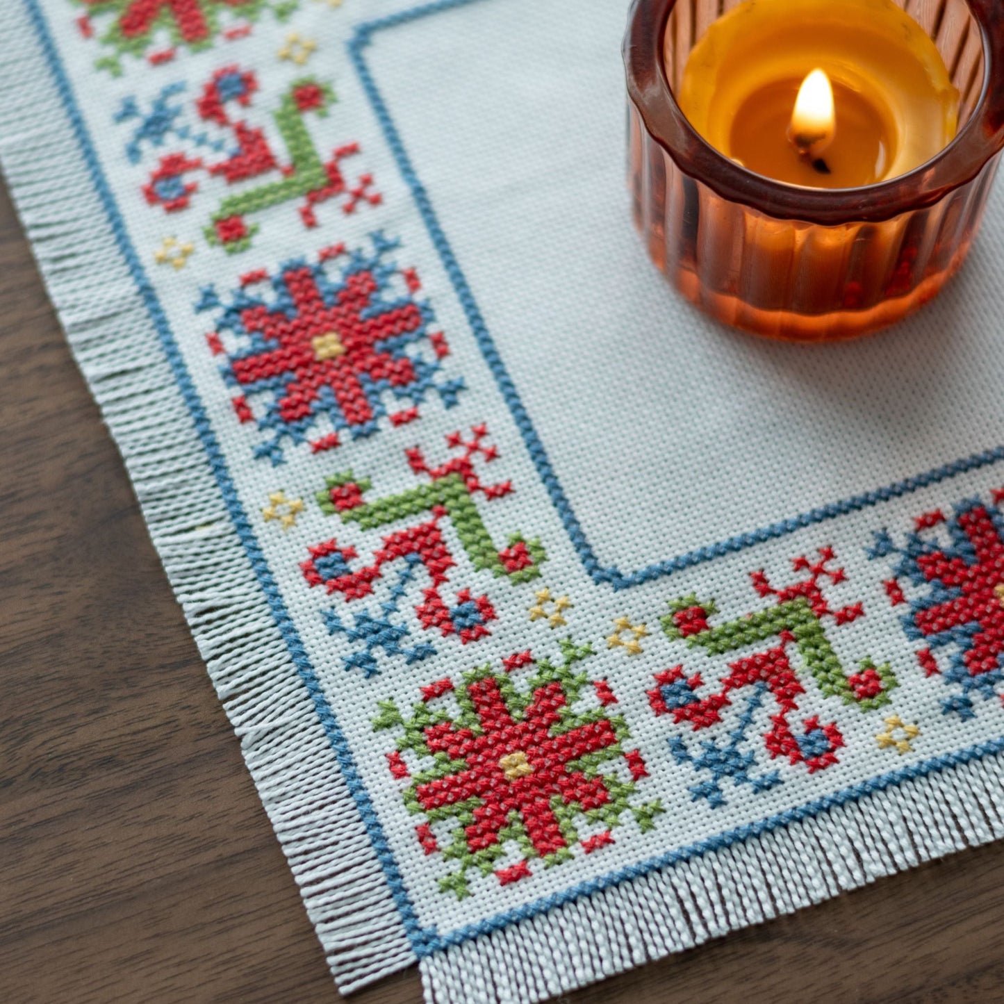 folk embroidery with red green and blue flower design