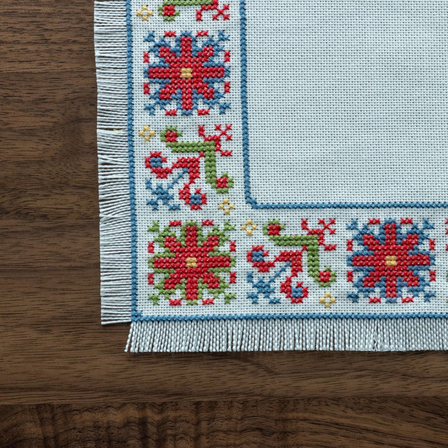 folk embroidery with red green and blue flower design