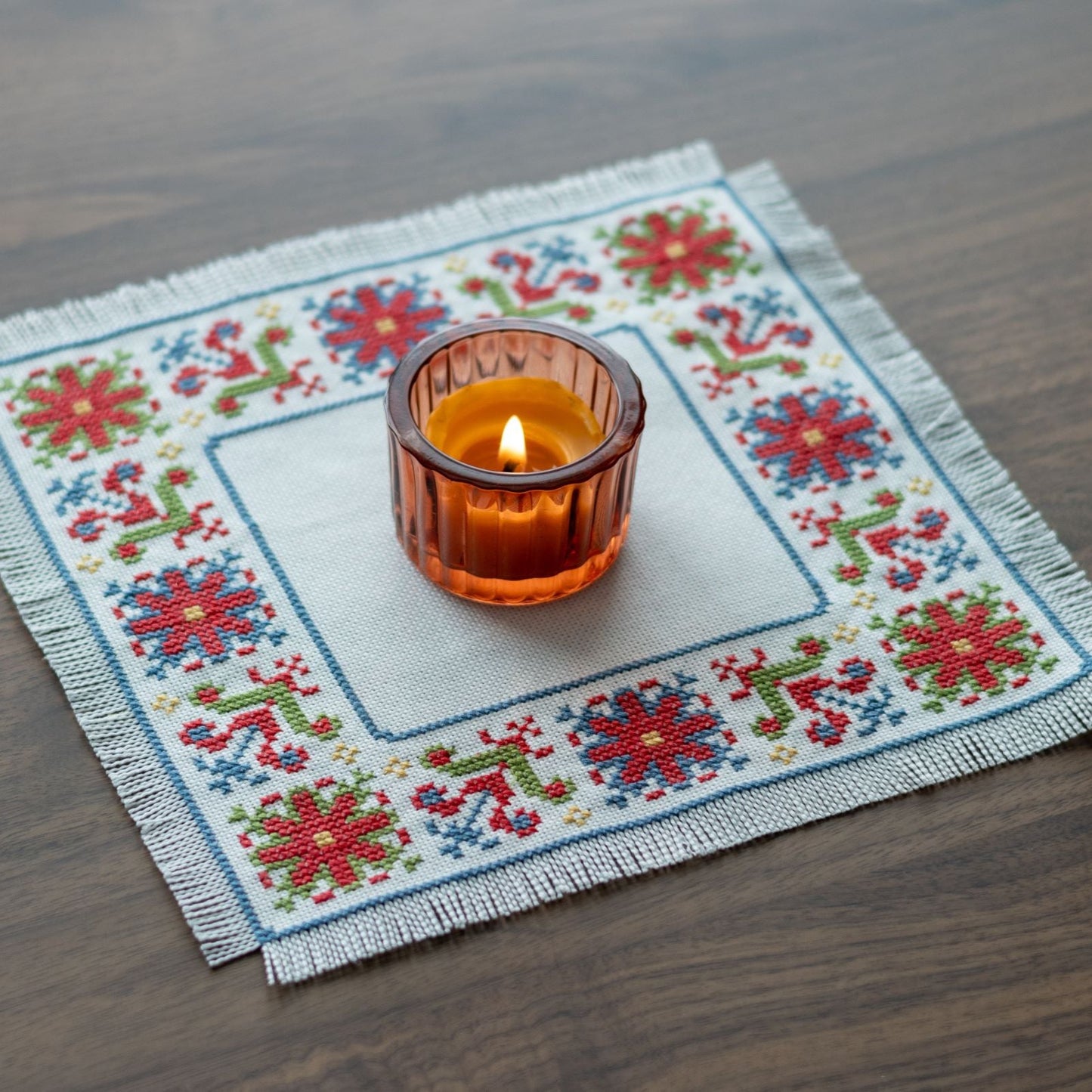 folk embroidery with red green and blue flower design