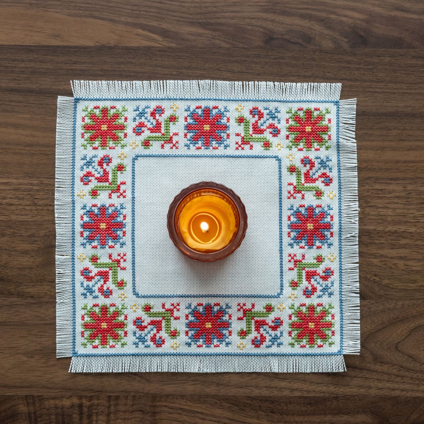 folk embroidery with red green and blue flower design