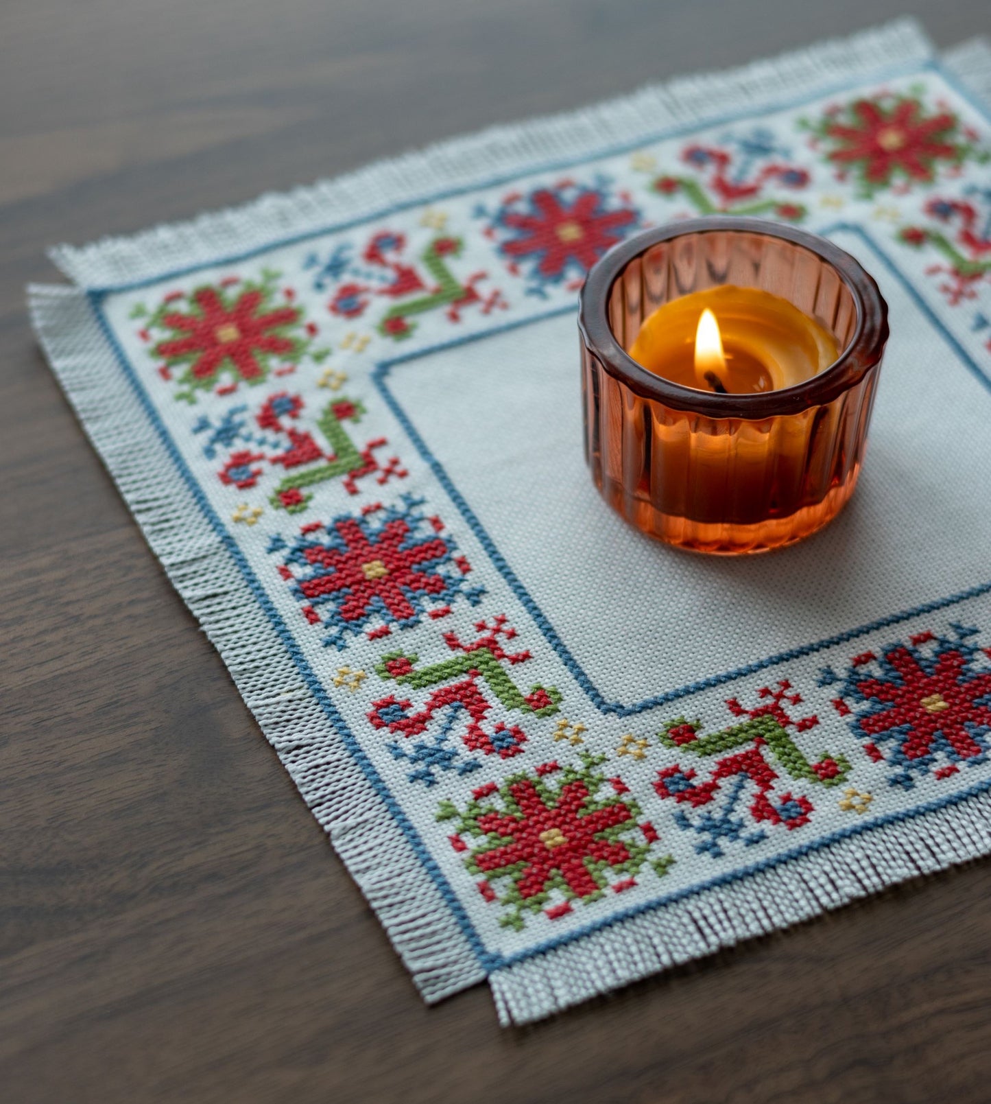 folk embroidery with red green and blue flower design