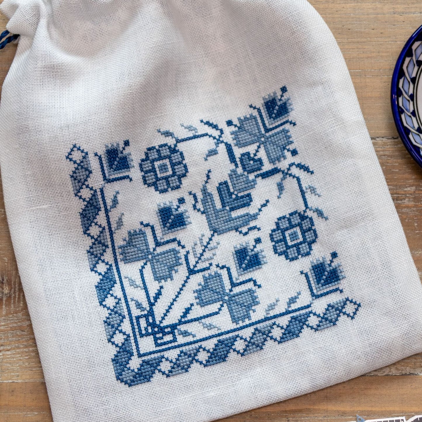 cross stitch bag with blue floral design