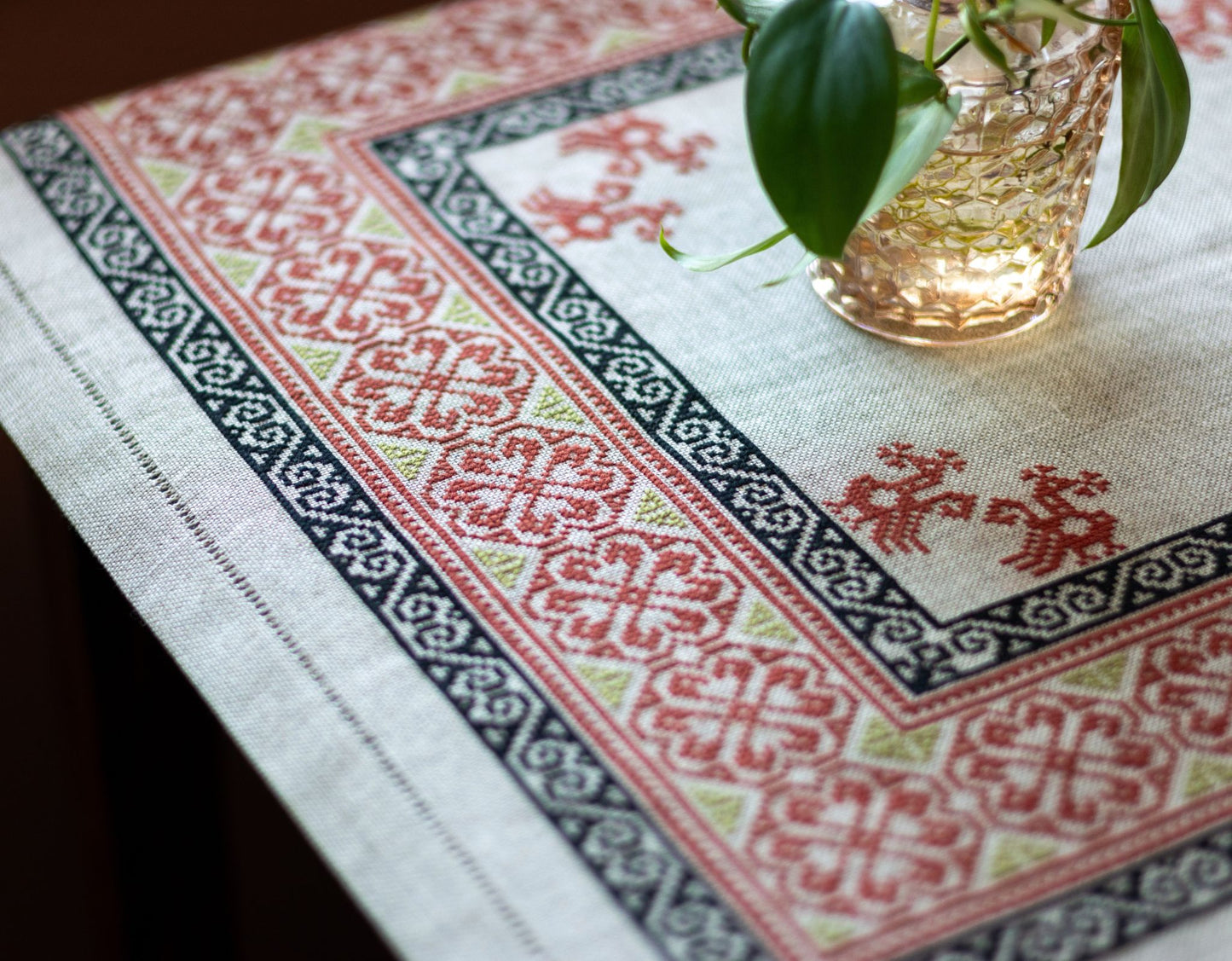 Decorative tablecloth with intricate patterns on a table.