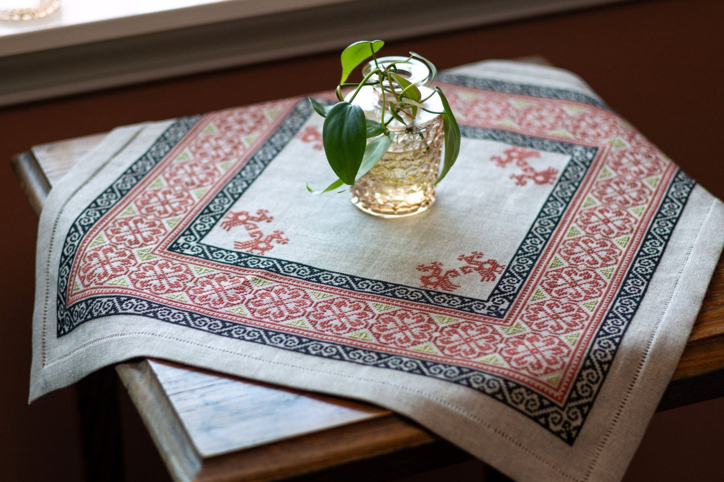 Decorative tablecloth with intricate patterns on a wooden surface