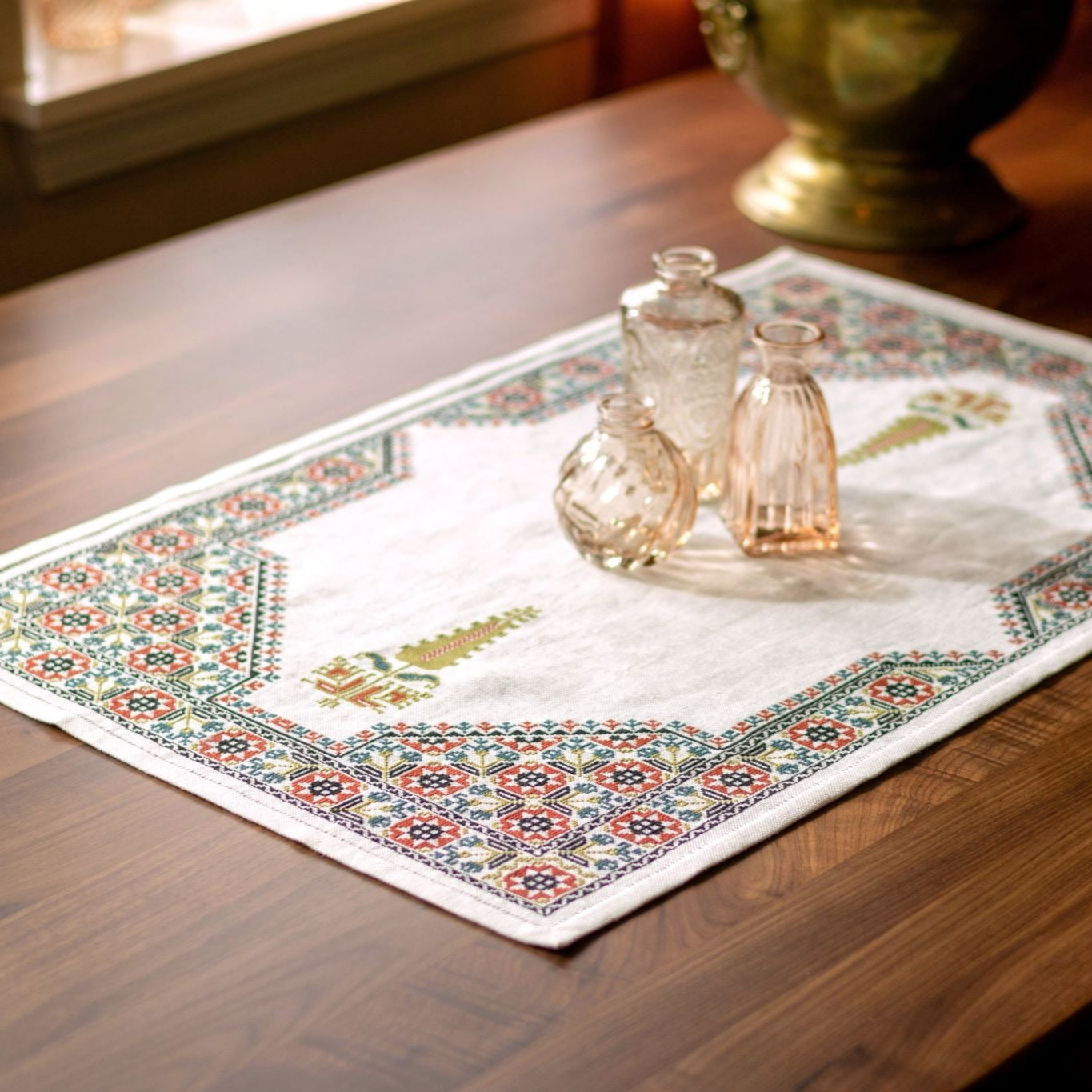 cross stitch folk embroidery table runner with stars, flowers, and cypress tree on white linen