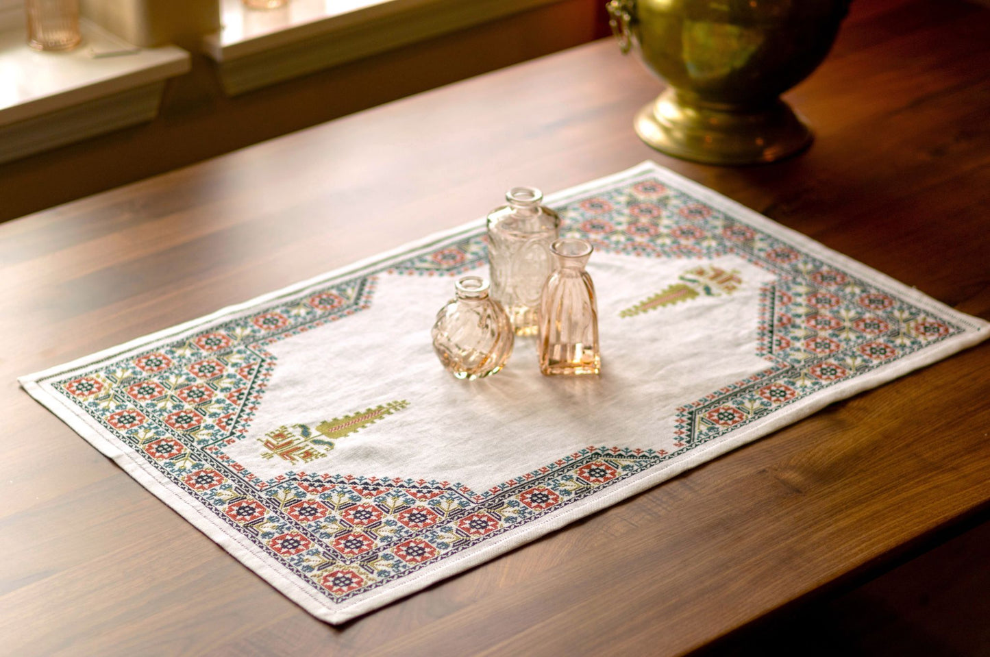 cross stitch folk embroidery table runner with stars, flowers, and cypress tree on white linen