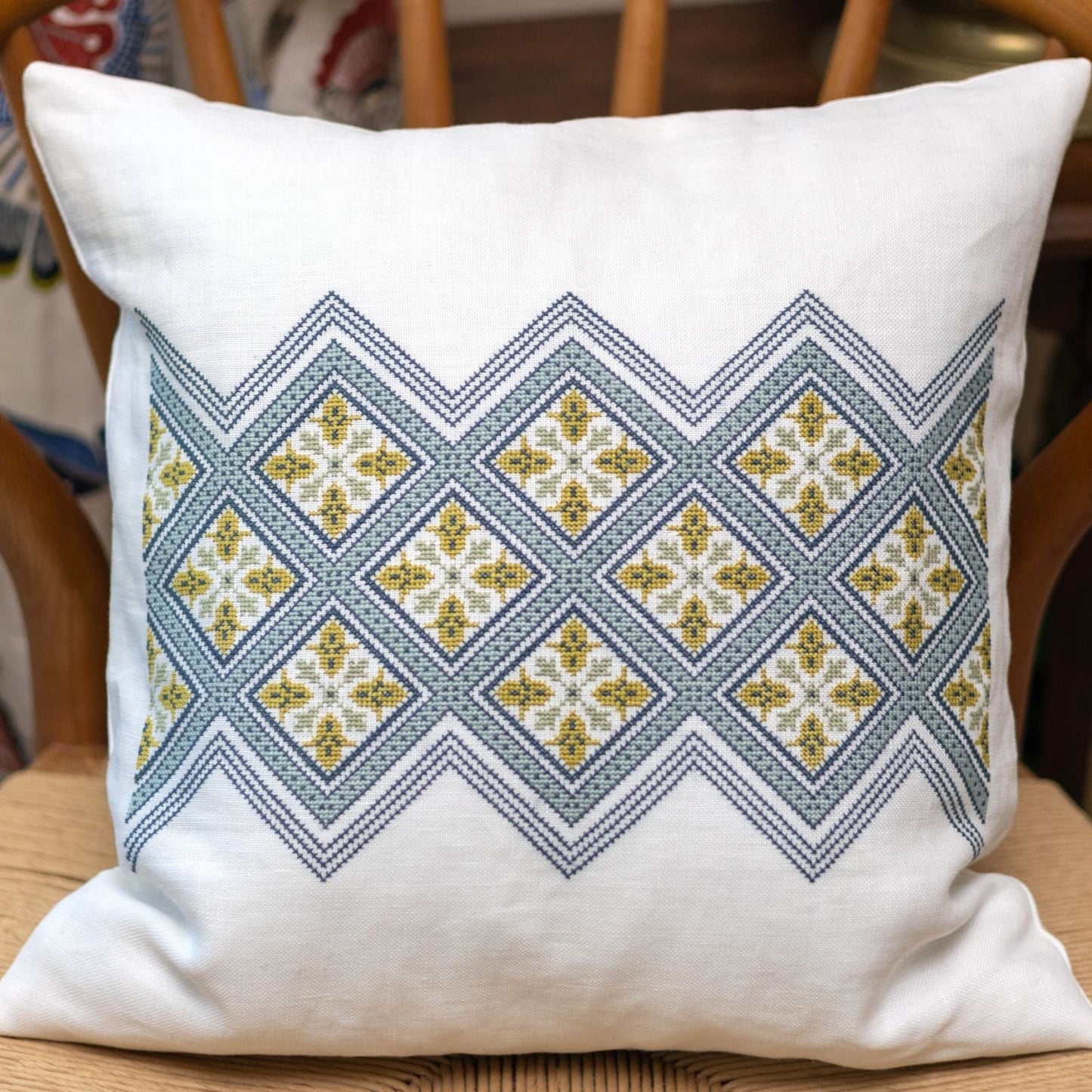 folk embroidery cushion with diamond design in blue
