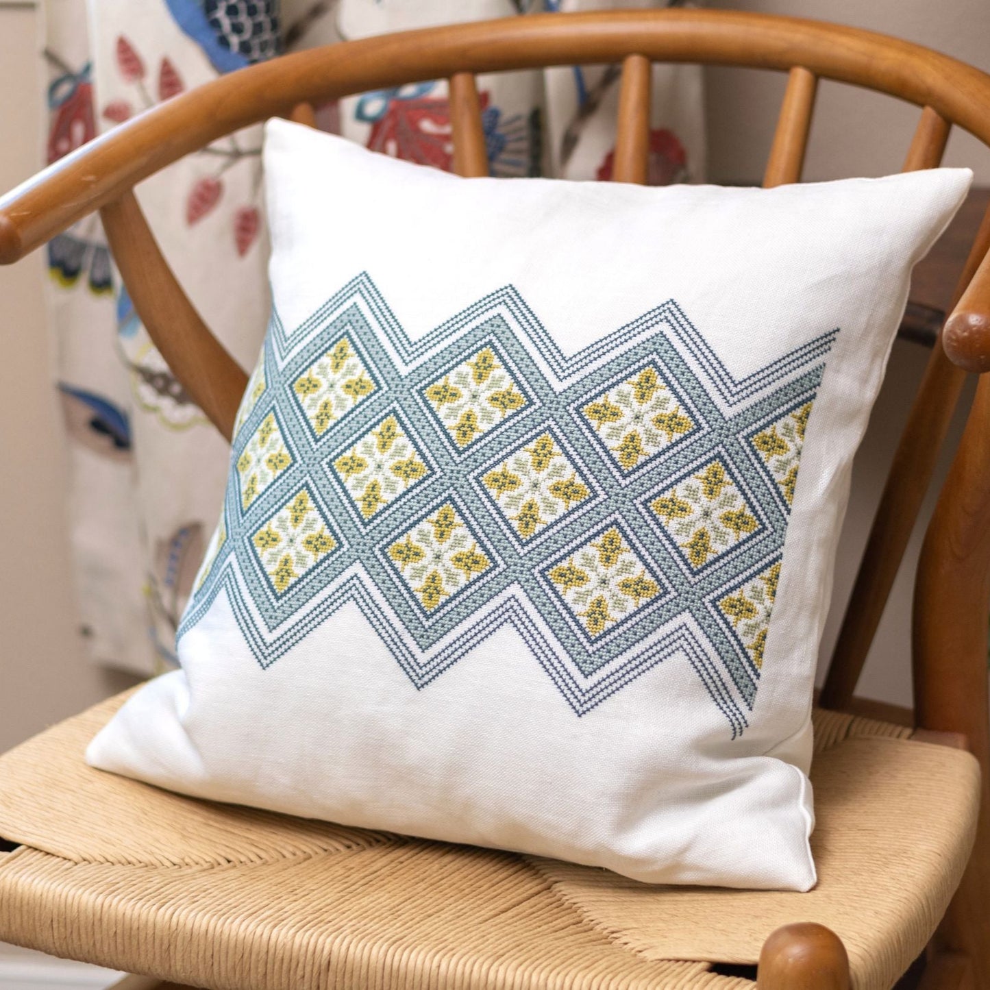 folk embroidery cushion with diamond design in blue