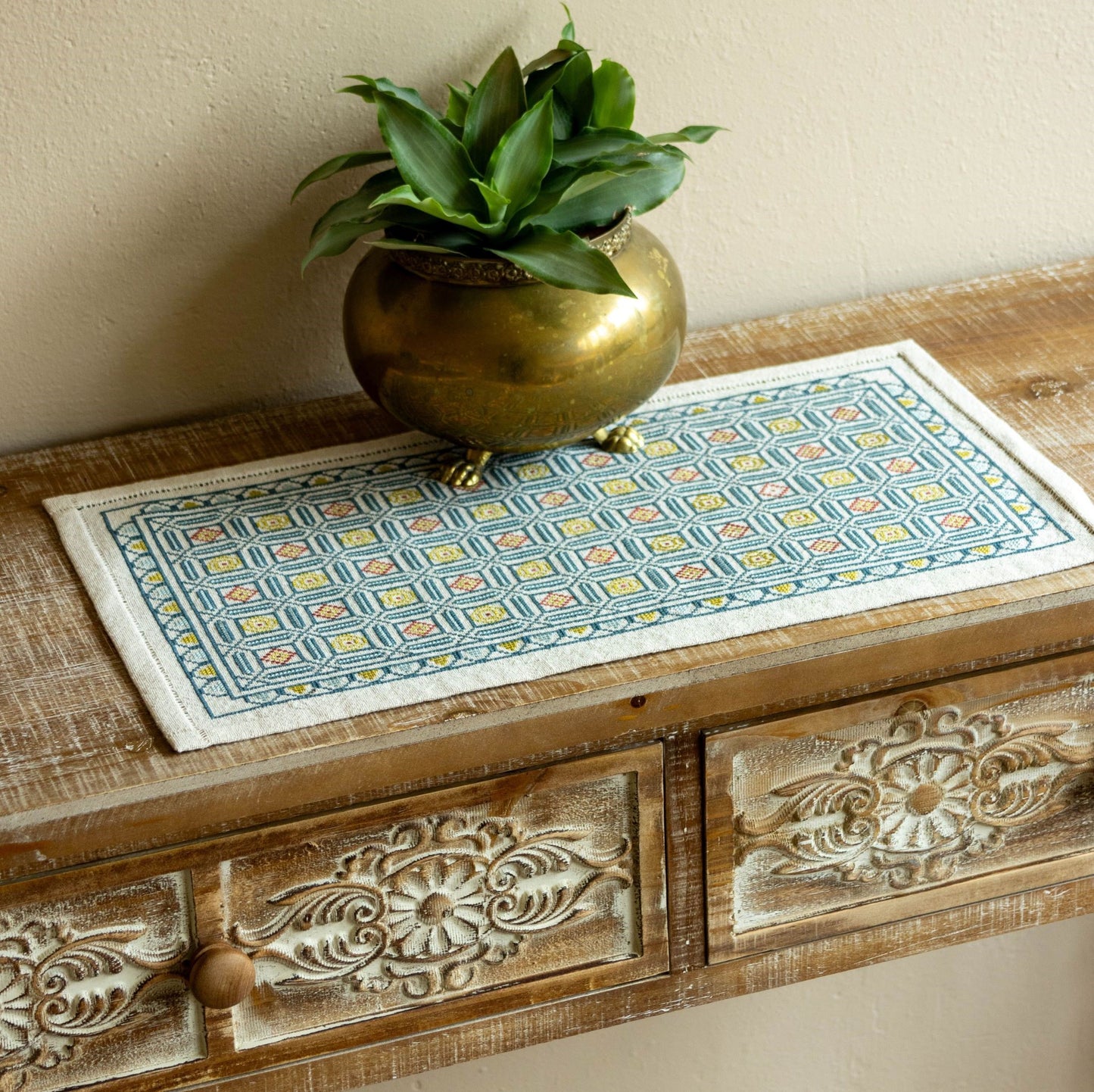 folk embroidery cross stitch with repeating tile design in blue
