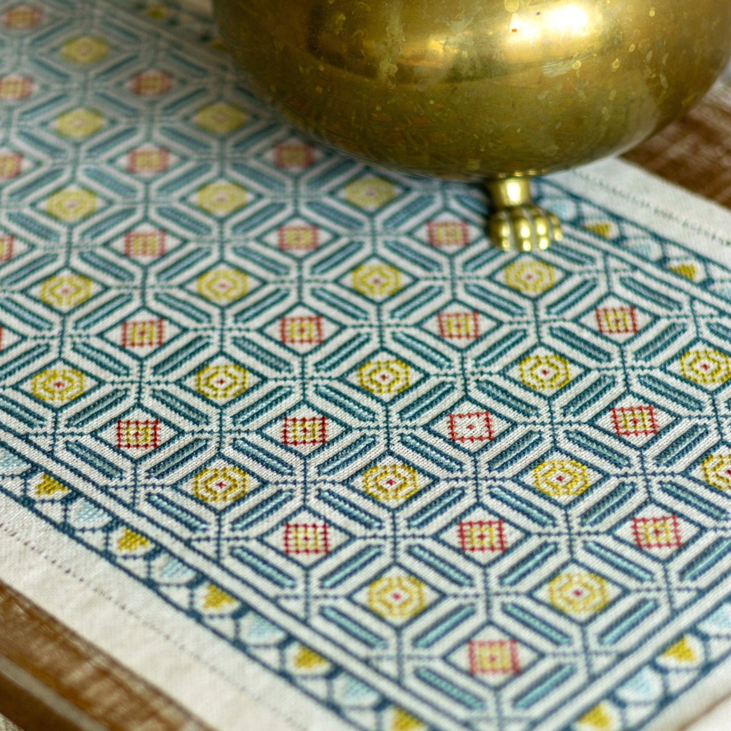 folk embroidery cross stitch with repeating tile design in blue
