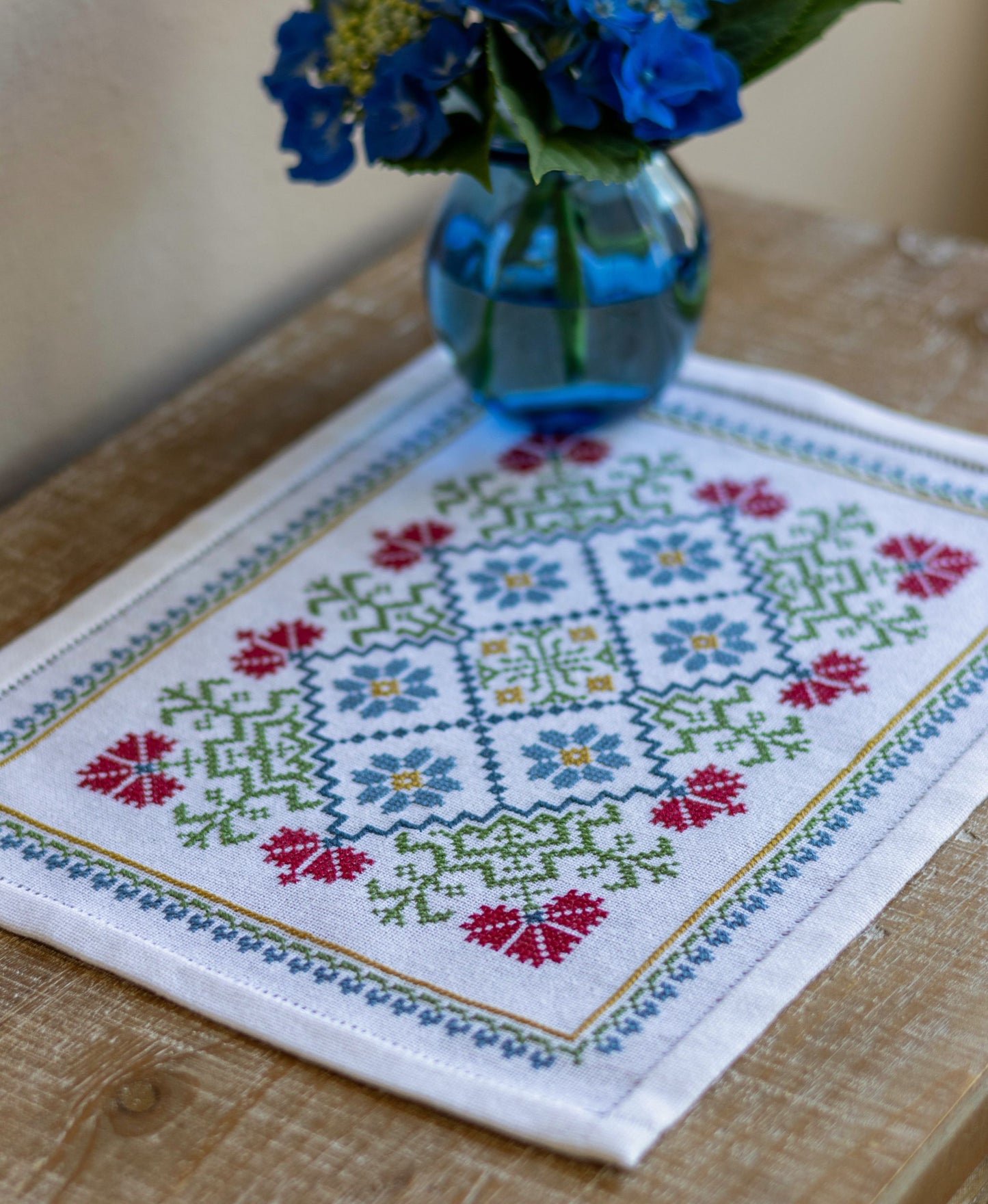 folk embroidery table mat with bright floral design