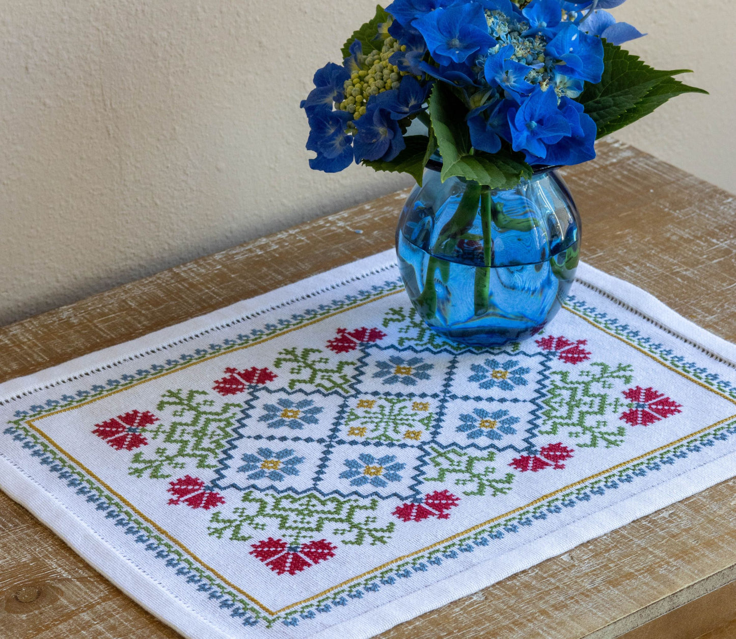 folk embroidery table mat with bright floral design