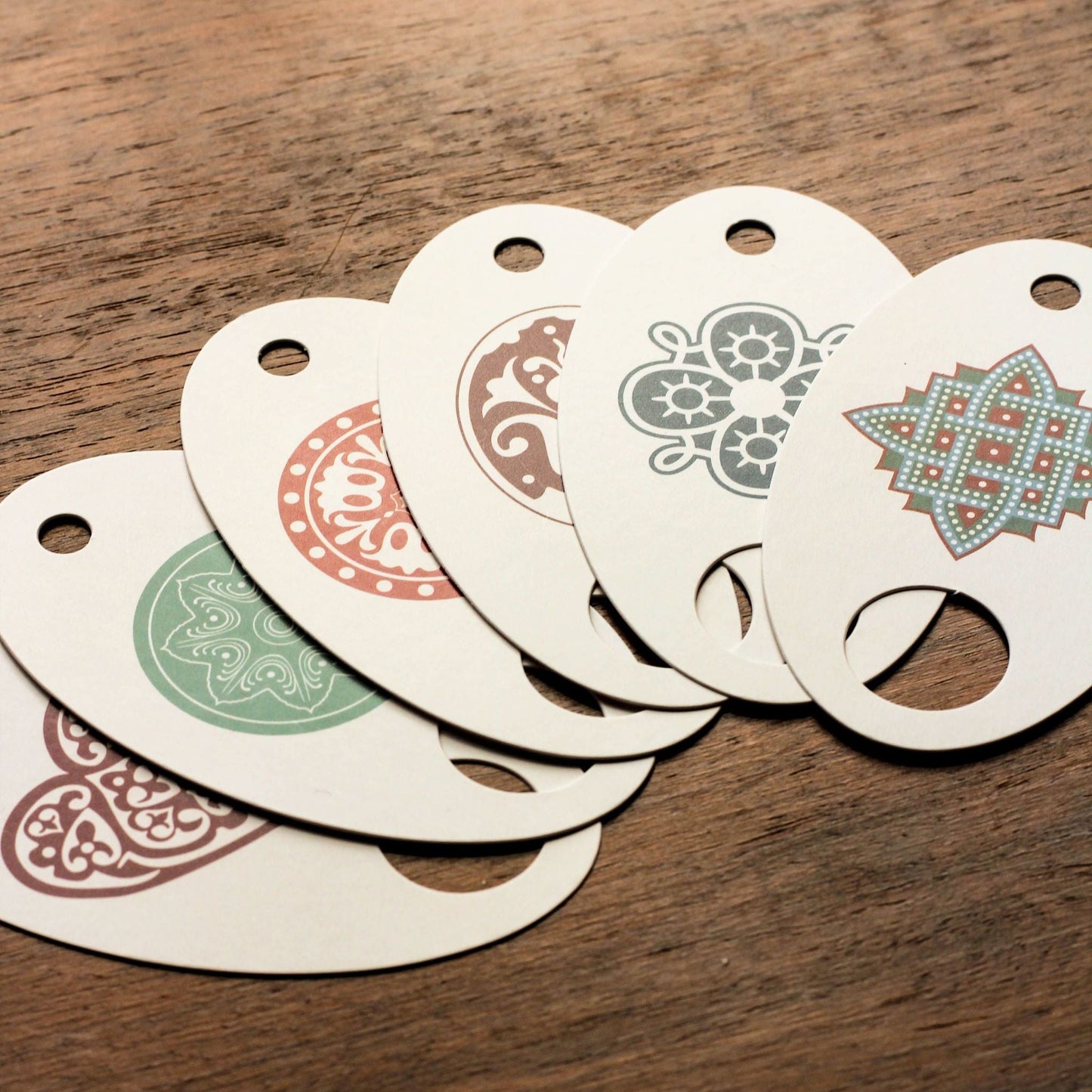 six folk embroidery floss organizers displayed with various decorative designs