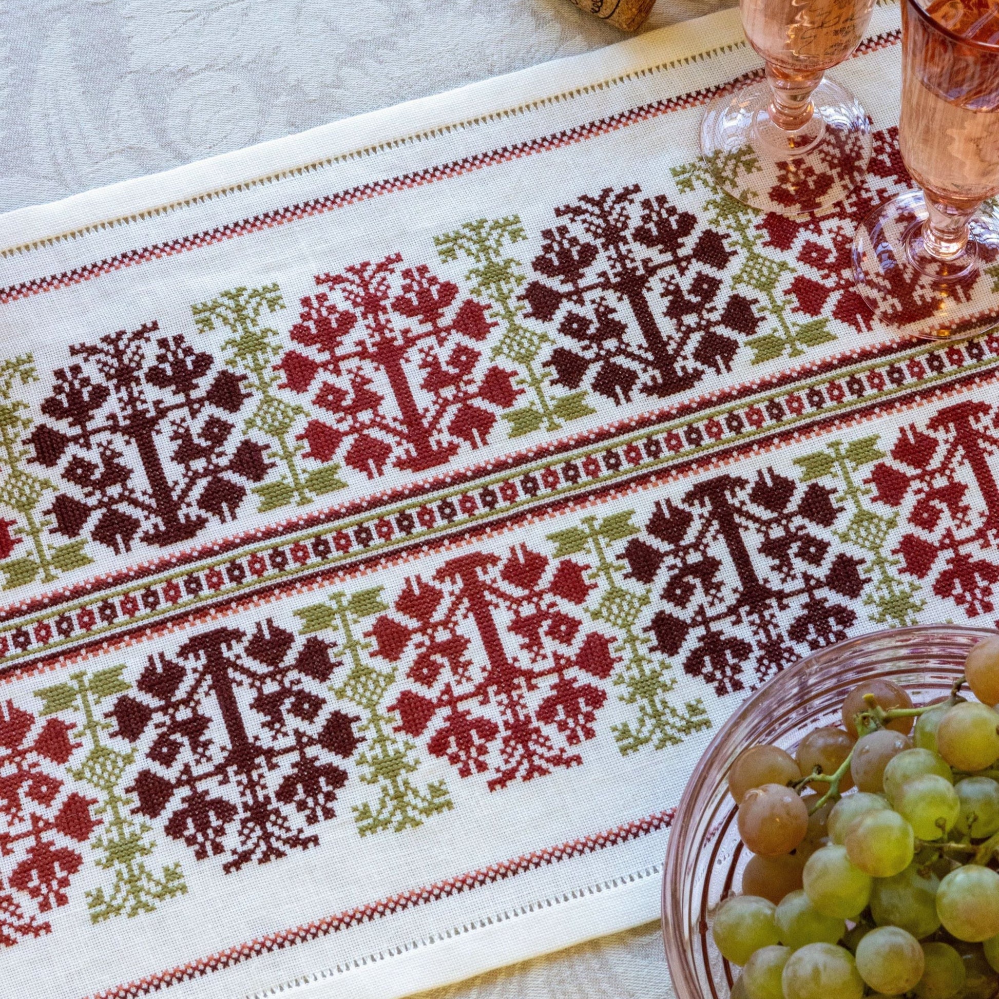 folk embroidery table runner with fig design in red