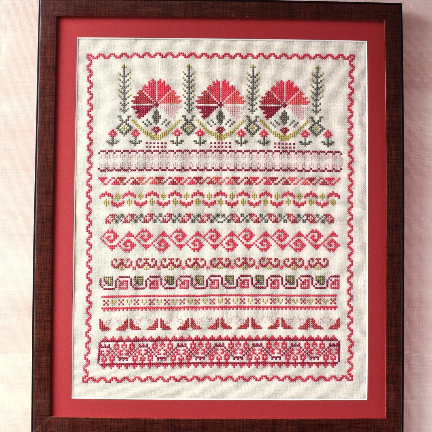 framed folk embroidery with borders in red