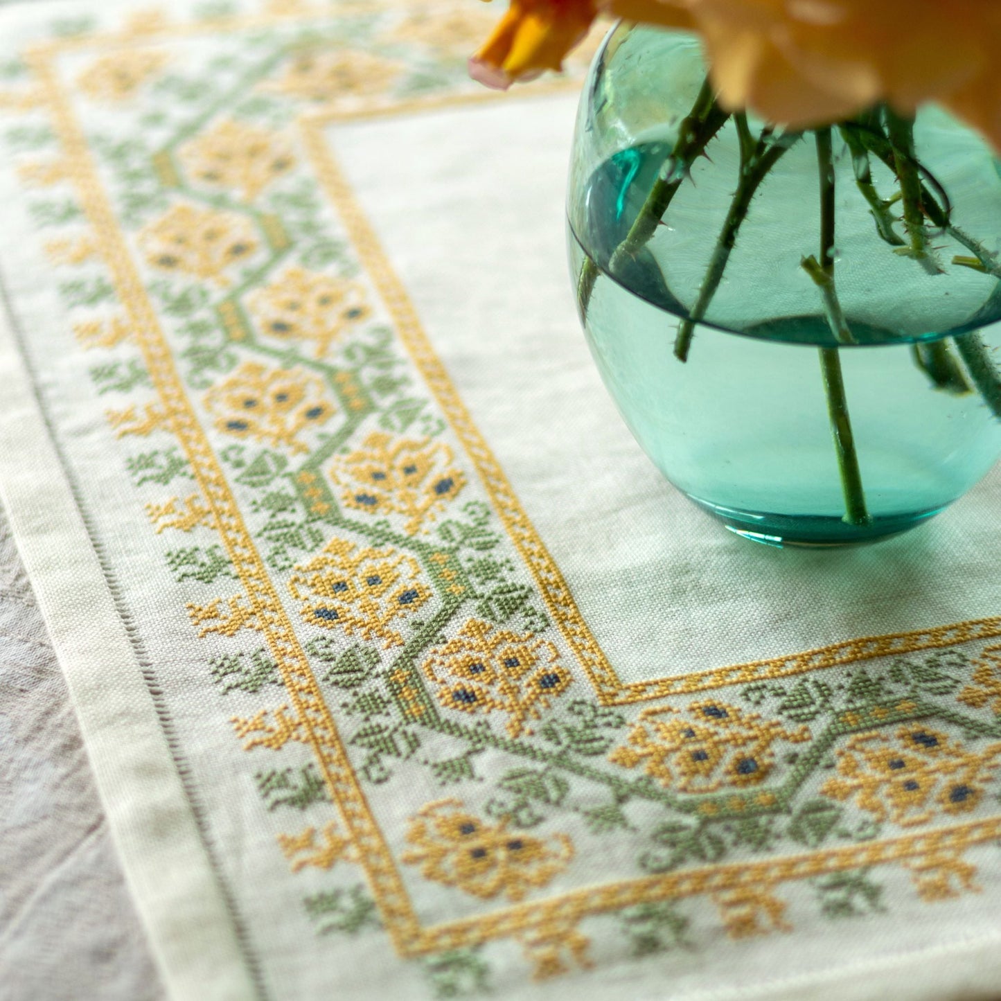 folk embroidery table linen with yellow and green floral design