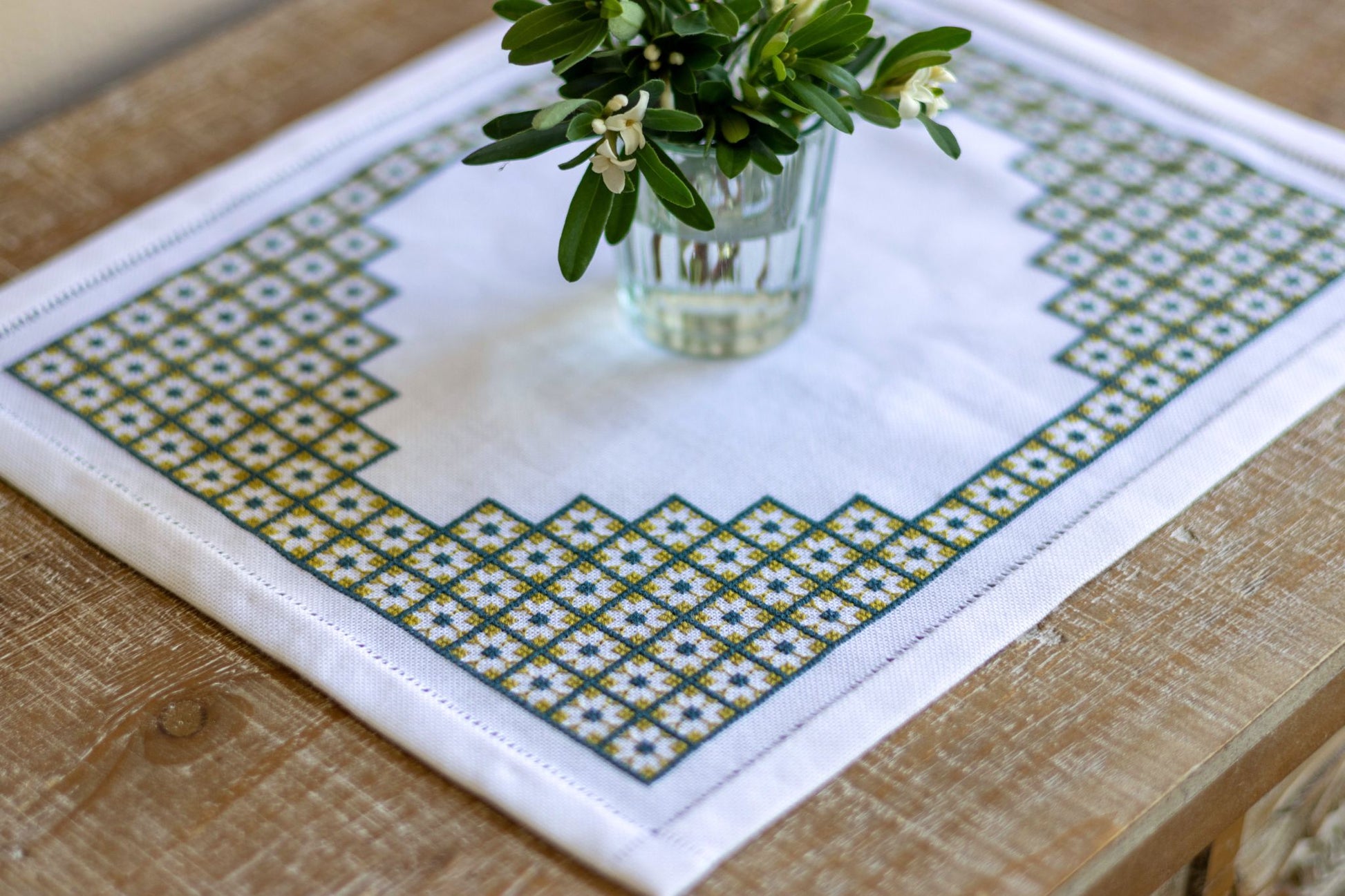 Decorative table mat with geometric pattern on a wooden surface