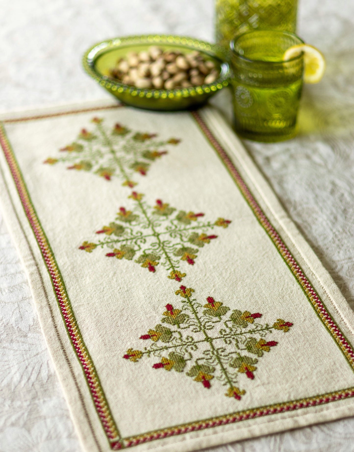 cross stitch folk embroidery design in green and red