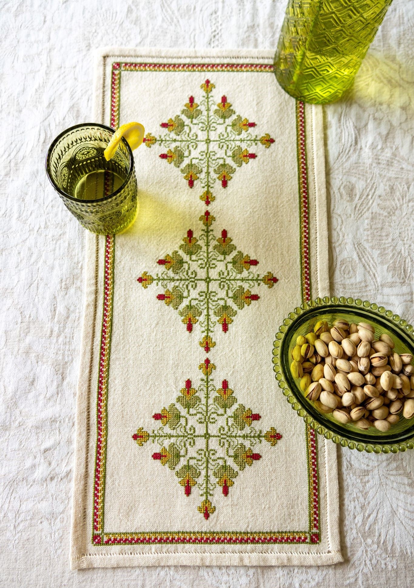 cross stitch folk embroidery design in green and red