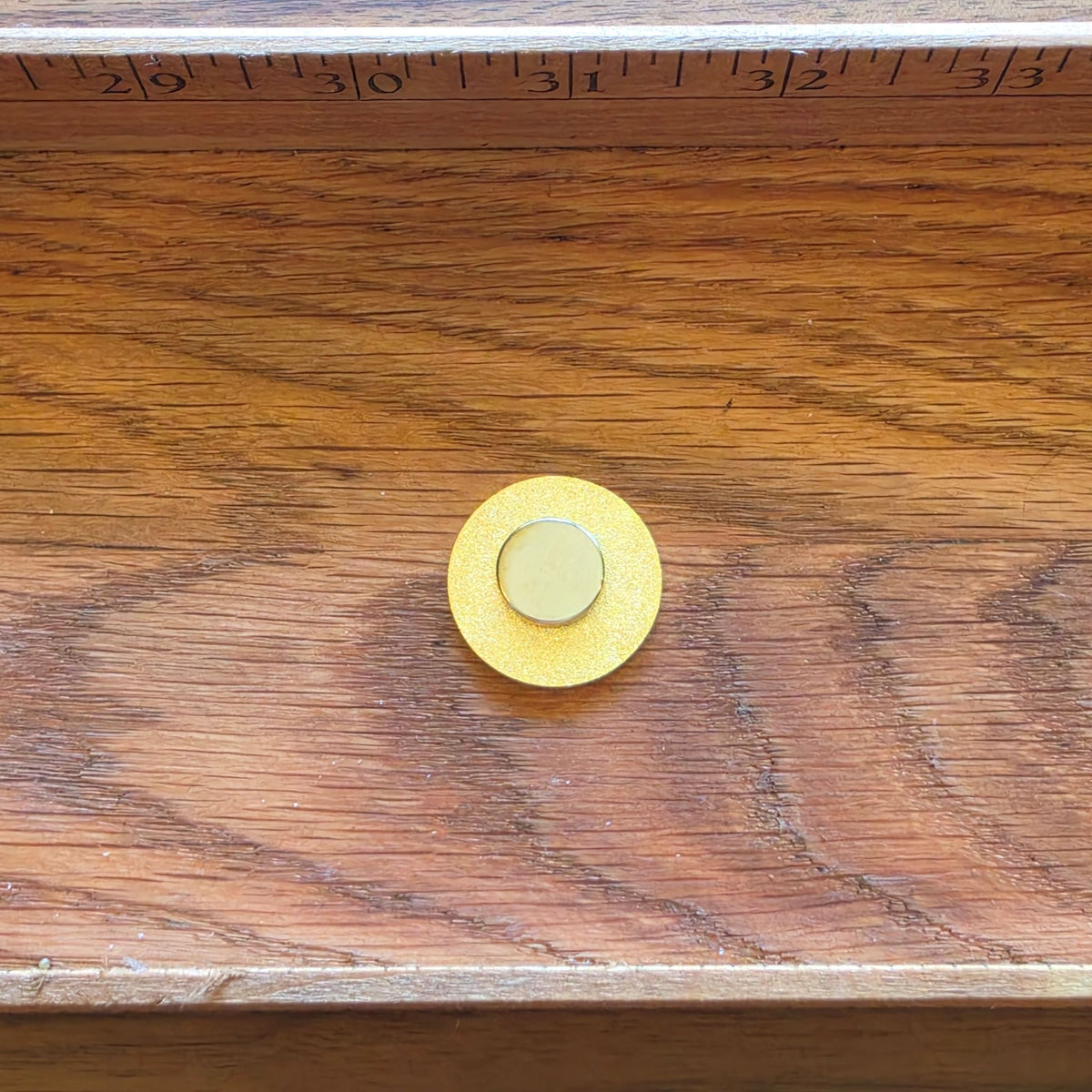 back of round needleminder showing magnet