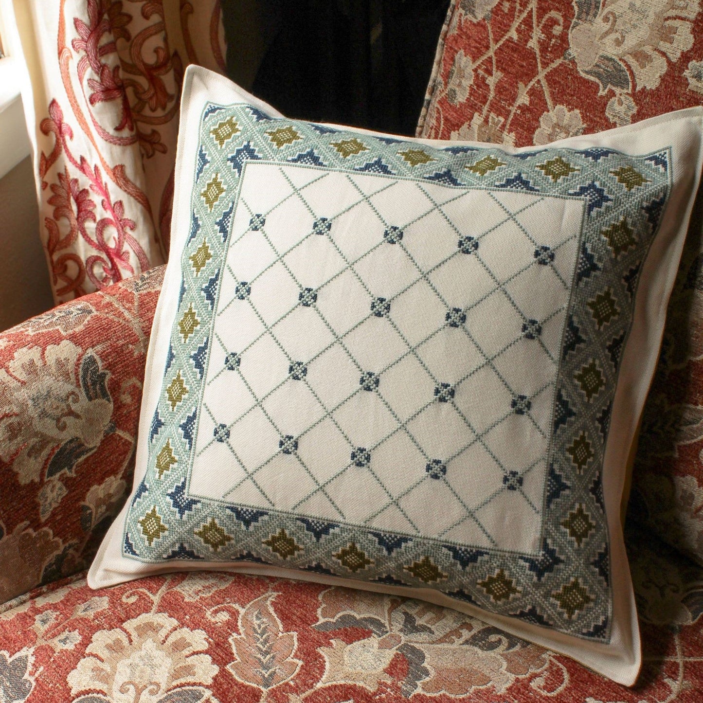 cross stitch folk embroidery cushion with repeating design in wool