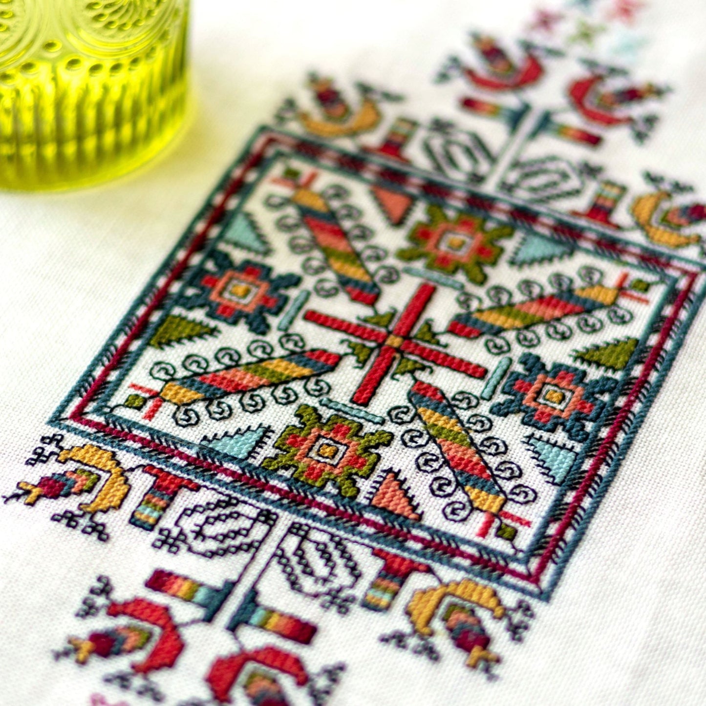 folk embroidery with geometric square design in multi colors