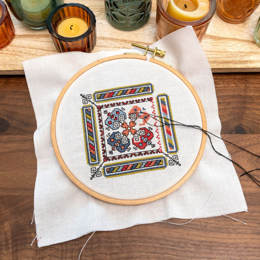 cross stitch folk embroidery in hoop showing backstitches