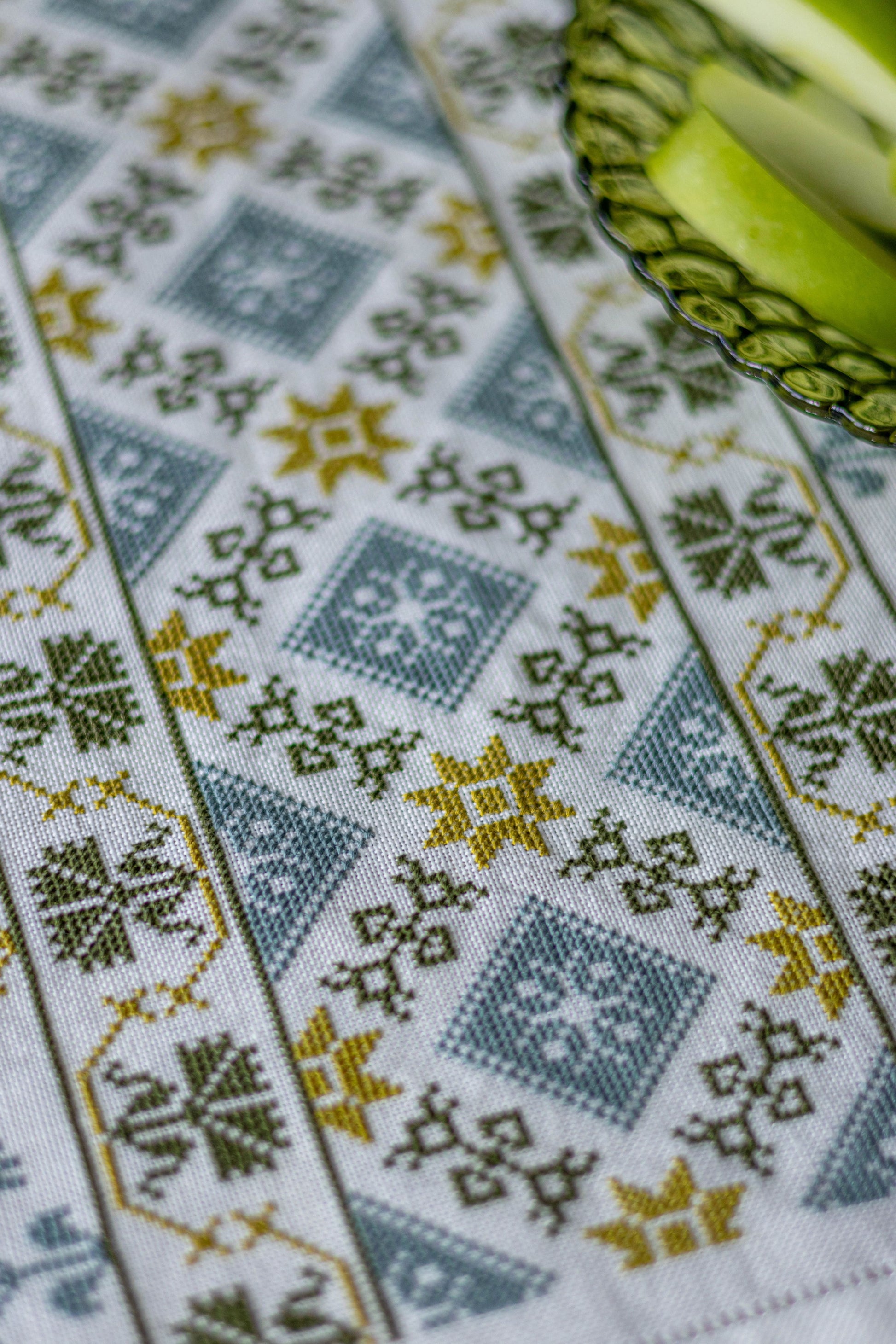 folk embroidery table runner in green and blue