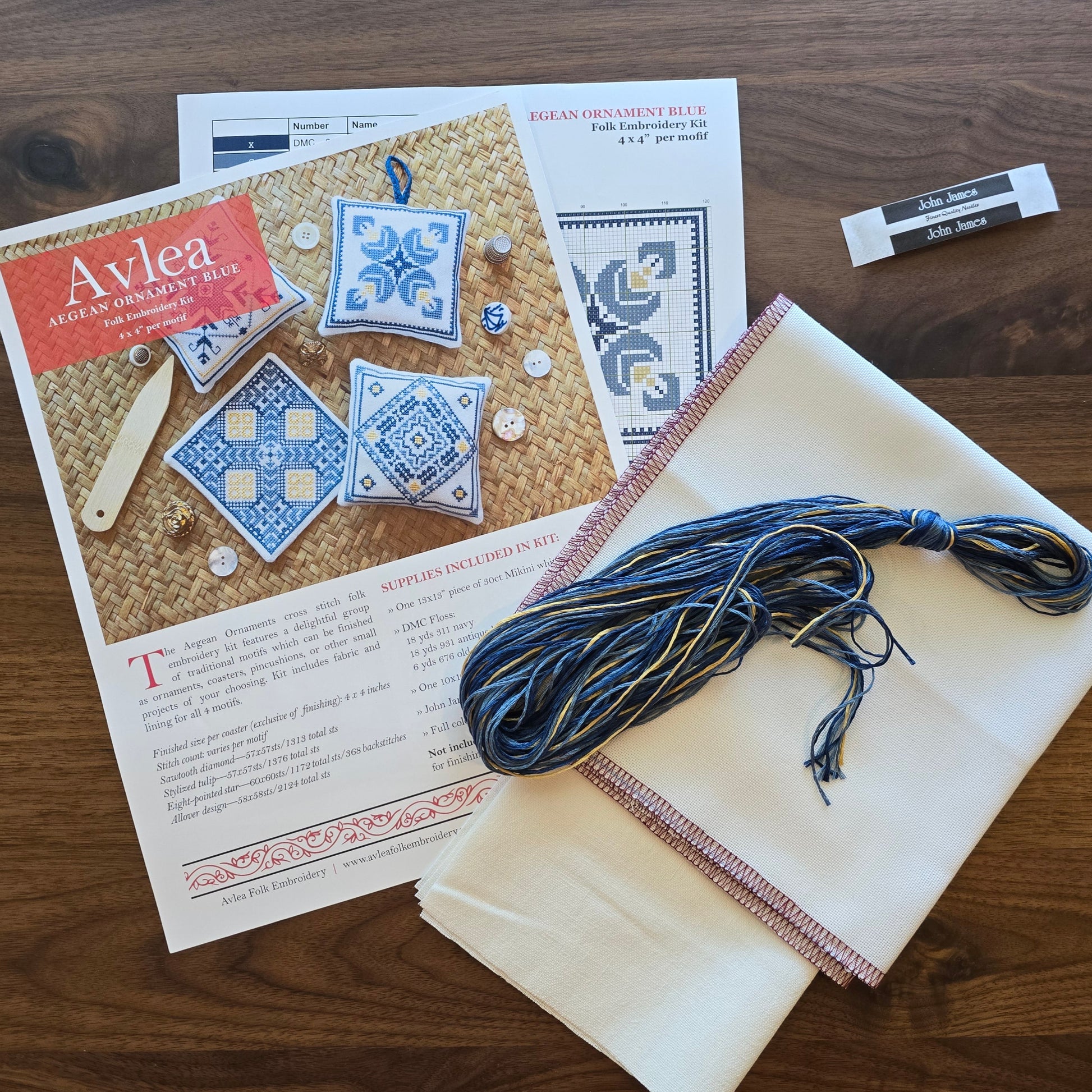 Embroidery kit with thread, fabric, and pattern on a wooden surface
