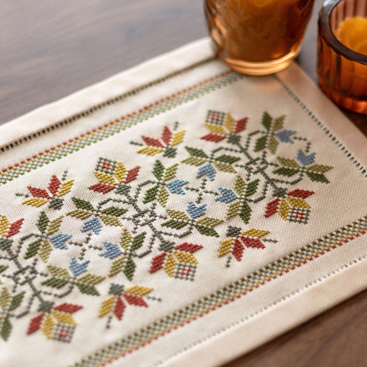 folk embroidery cross stitch table mat with leaves in fall palette