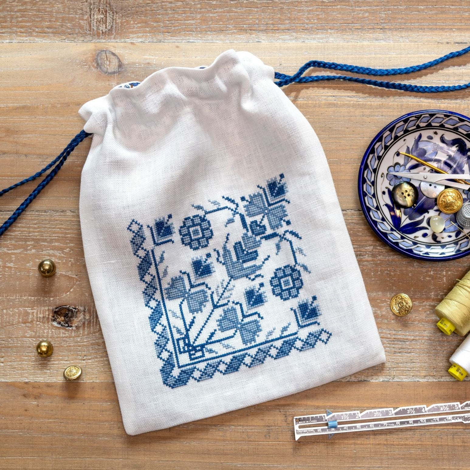 cross stitch bag with blue floral design