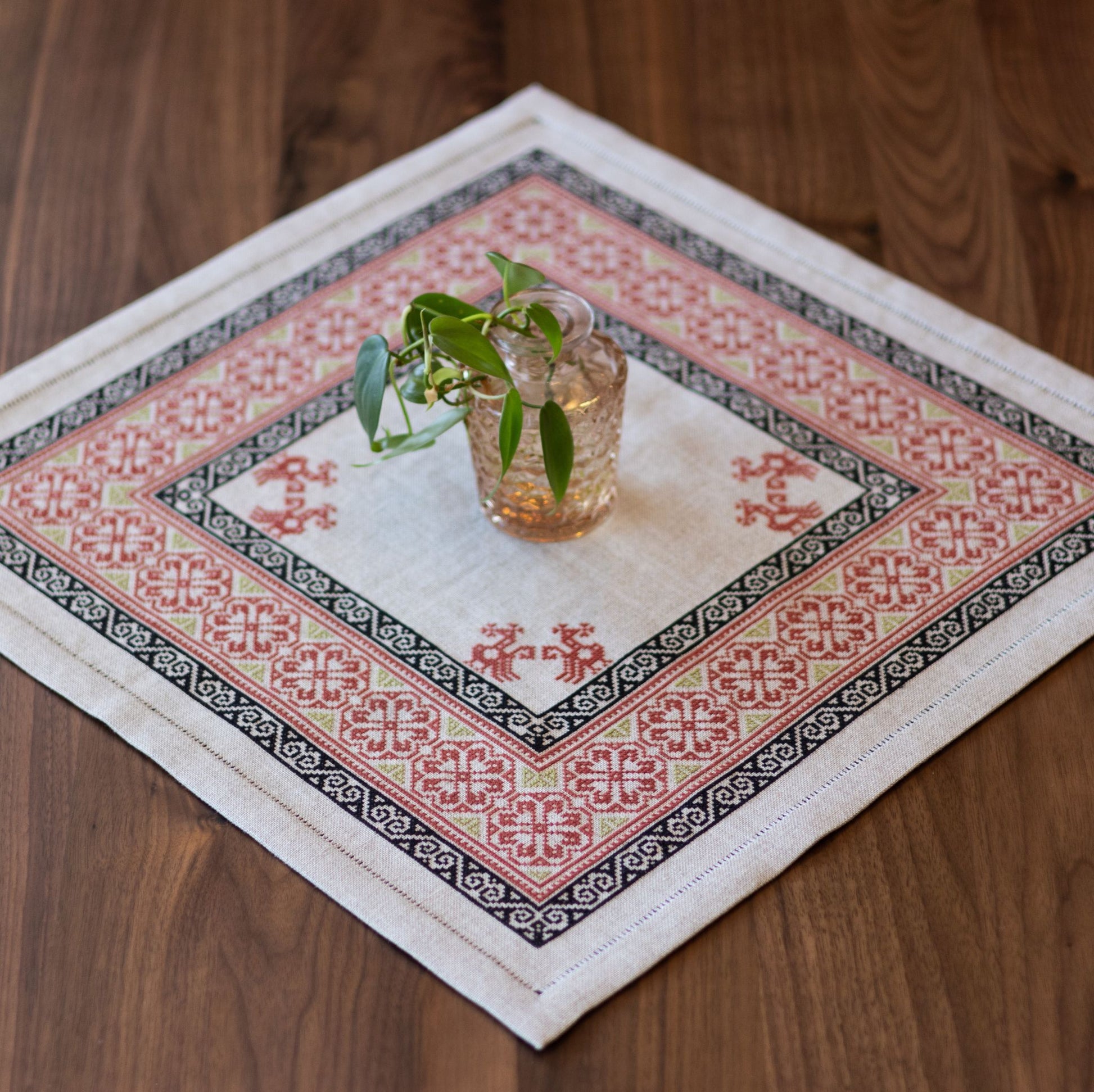 Decorative table mat with geometric pattern on a wooden surface