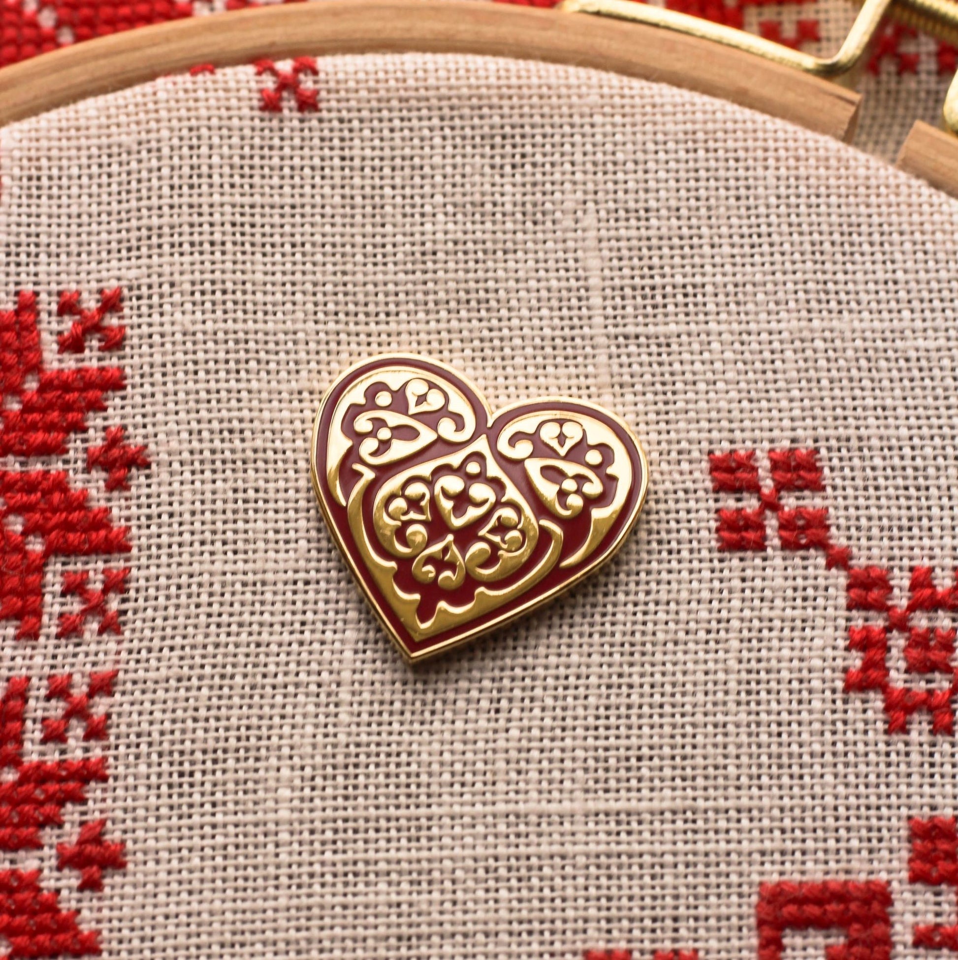 folk embroidery with enamel needleminder in shape of heart