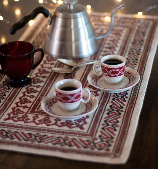 folk embroidery table runner in black and red with coffee cups