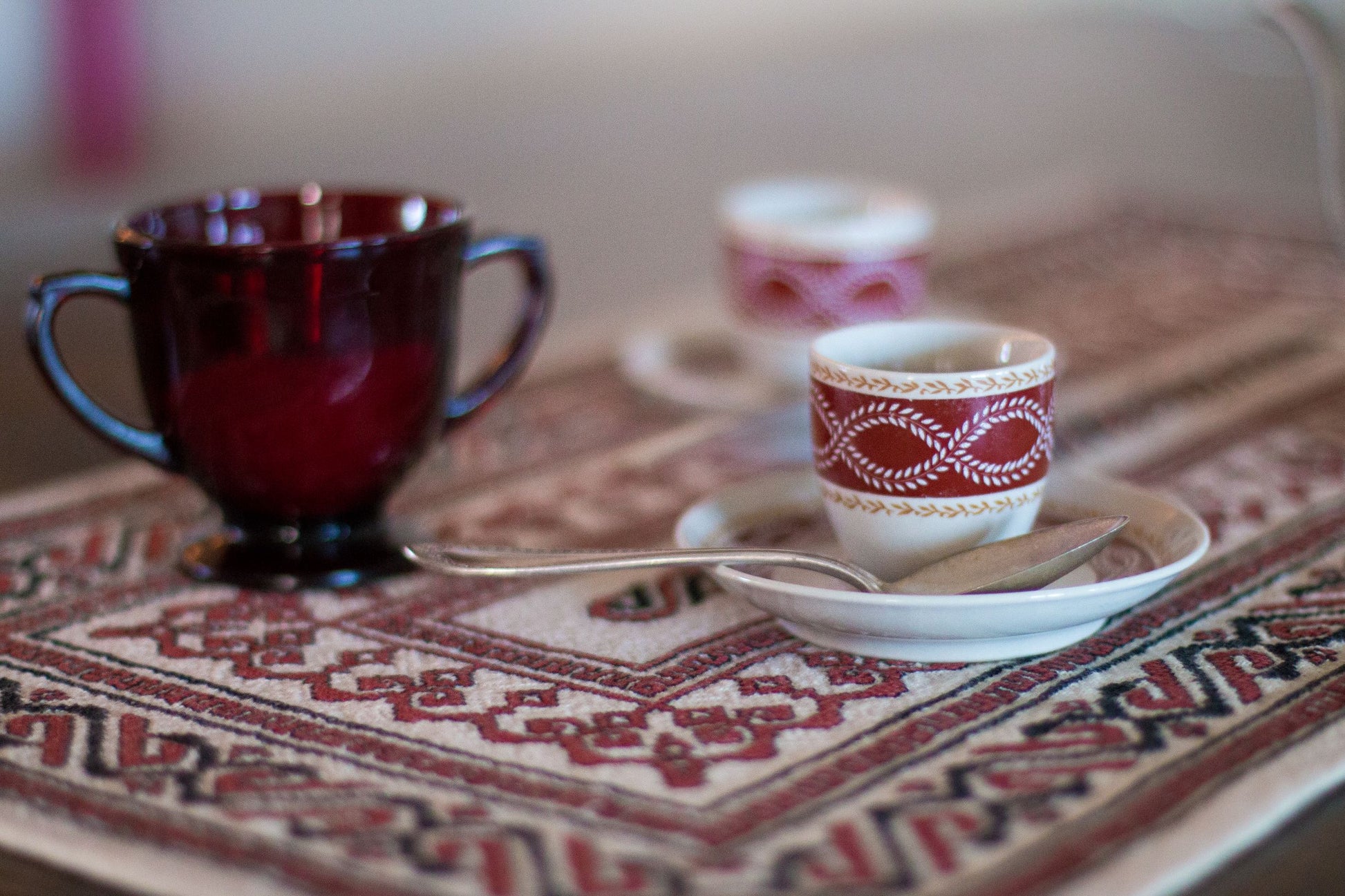 folk embroidery table runner in black and red with coffee cups