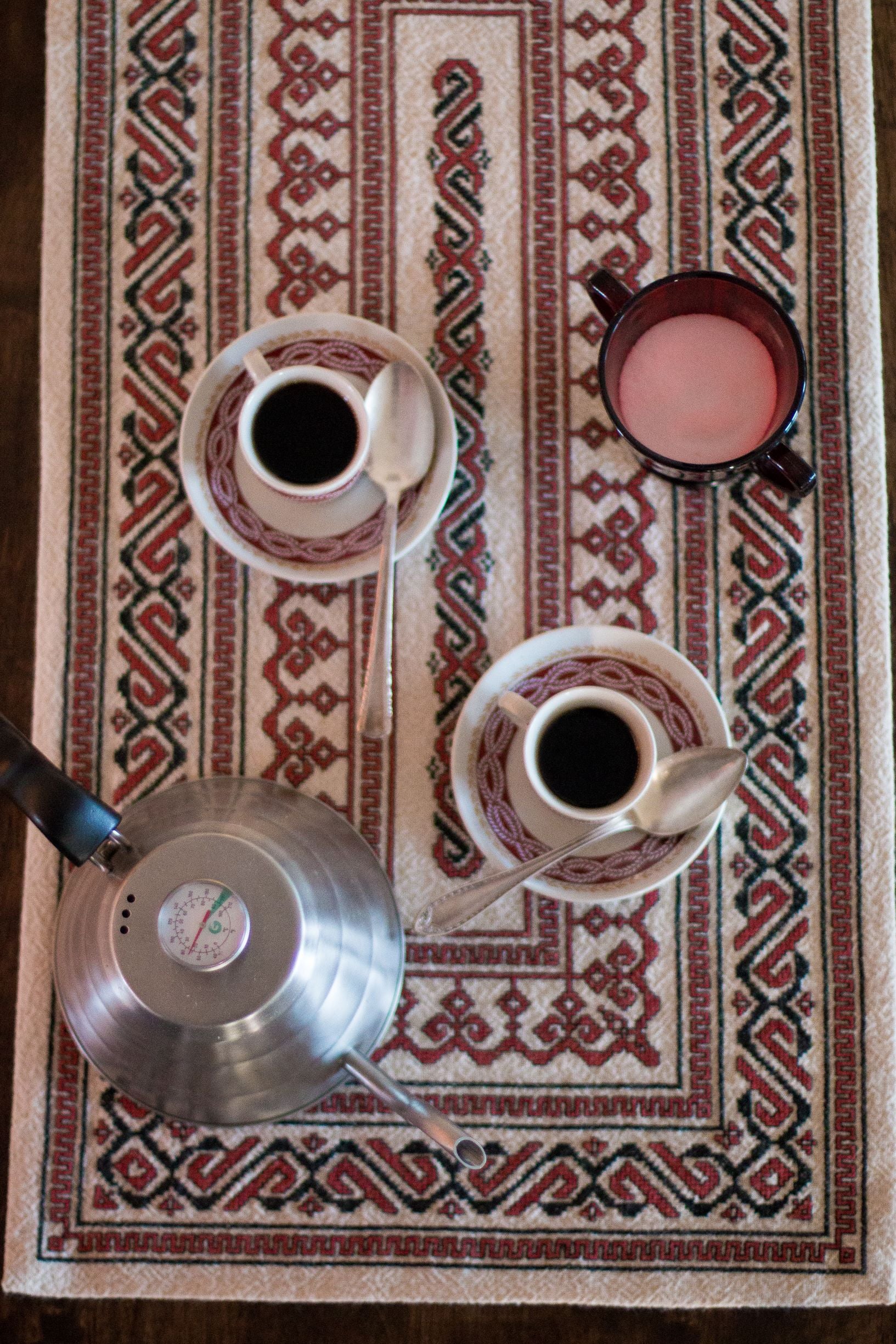 folk embroidery table runner in black and red with coffee cups