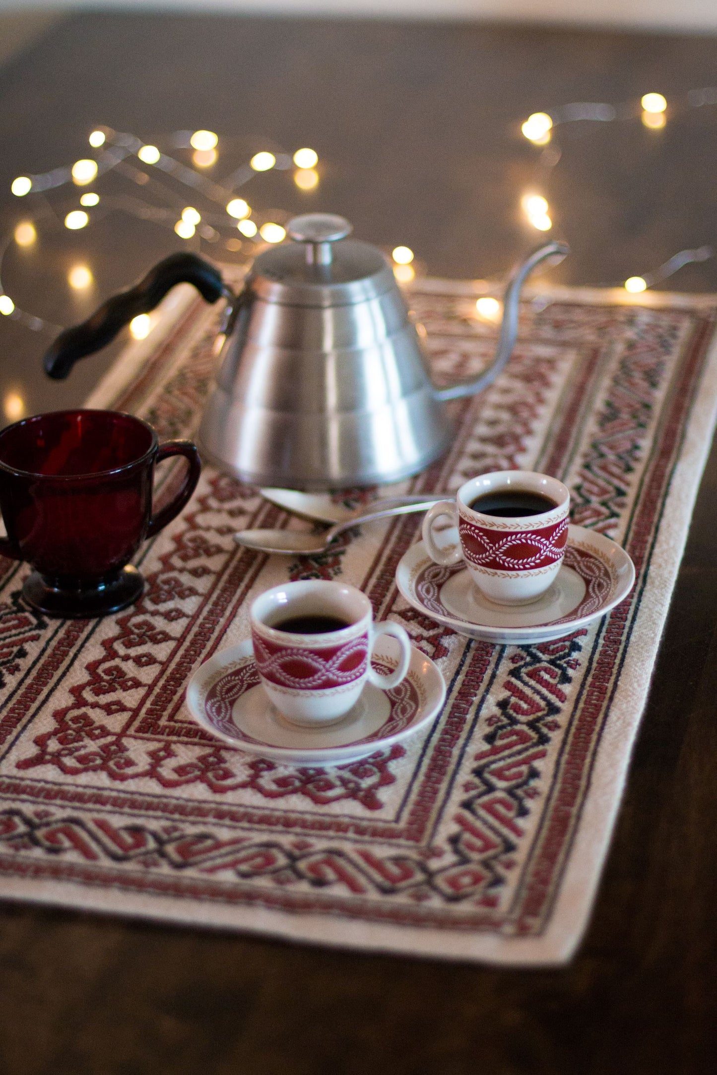 folk embroidery table runner in black and red with coffee cups