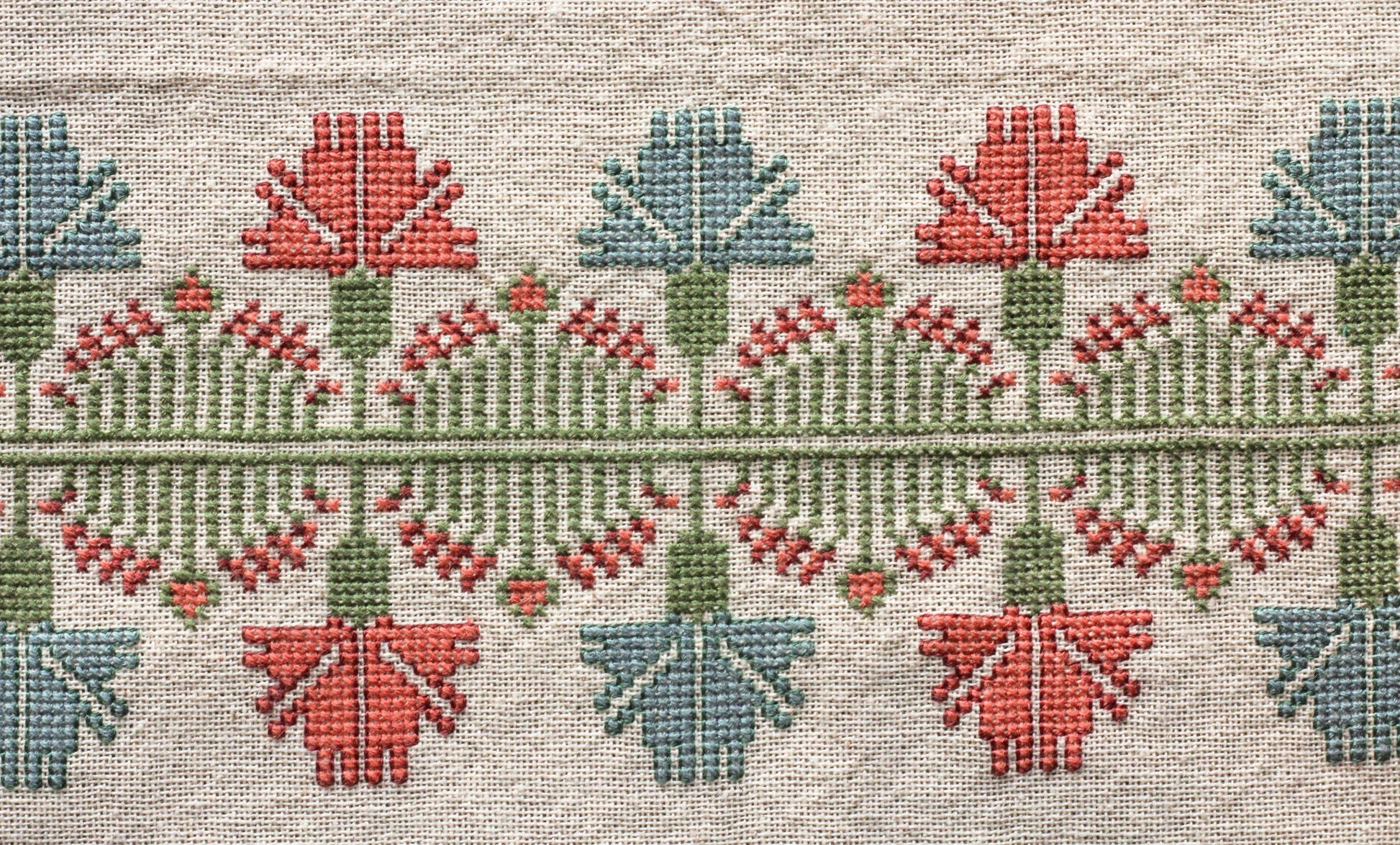 folk embroidery with pink and blue floral design