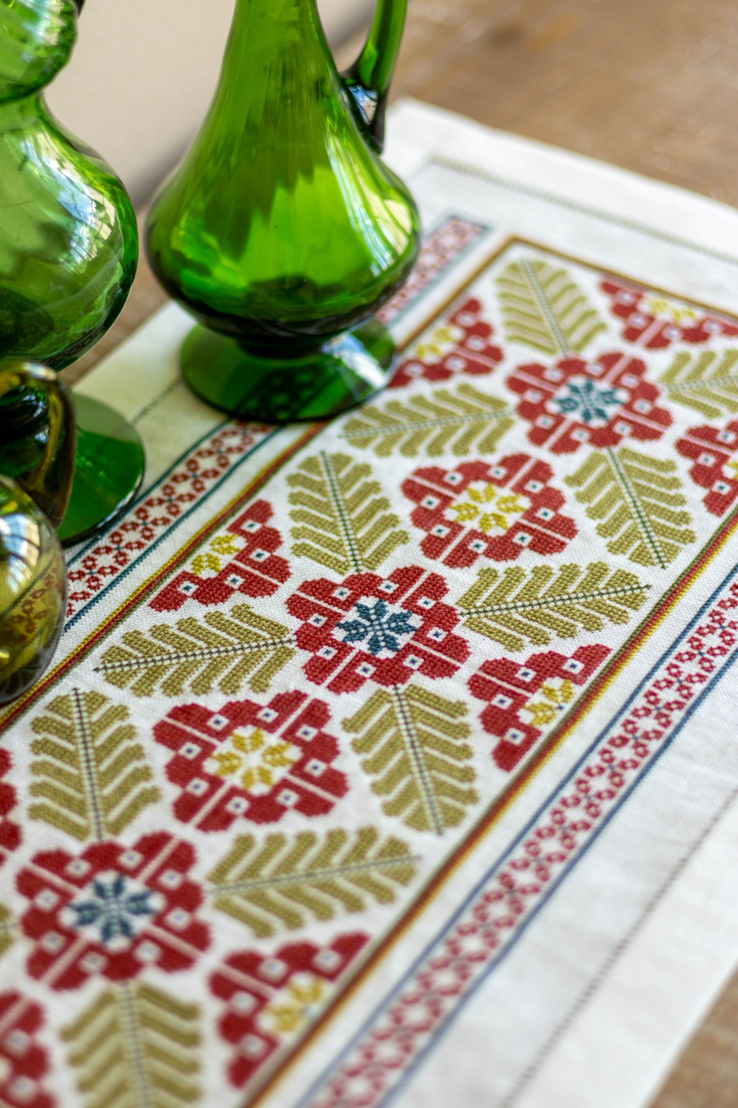 folk embroidery table runner with broad leaf design