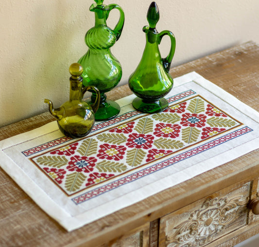 folk embroidery table runner with broad leaf design