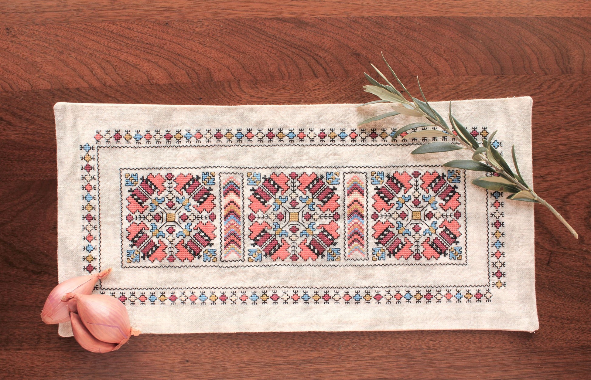 folk embroidery runner with coral and black design