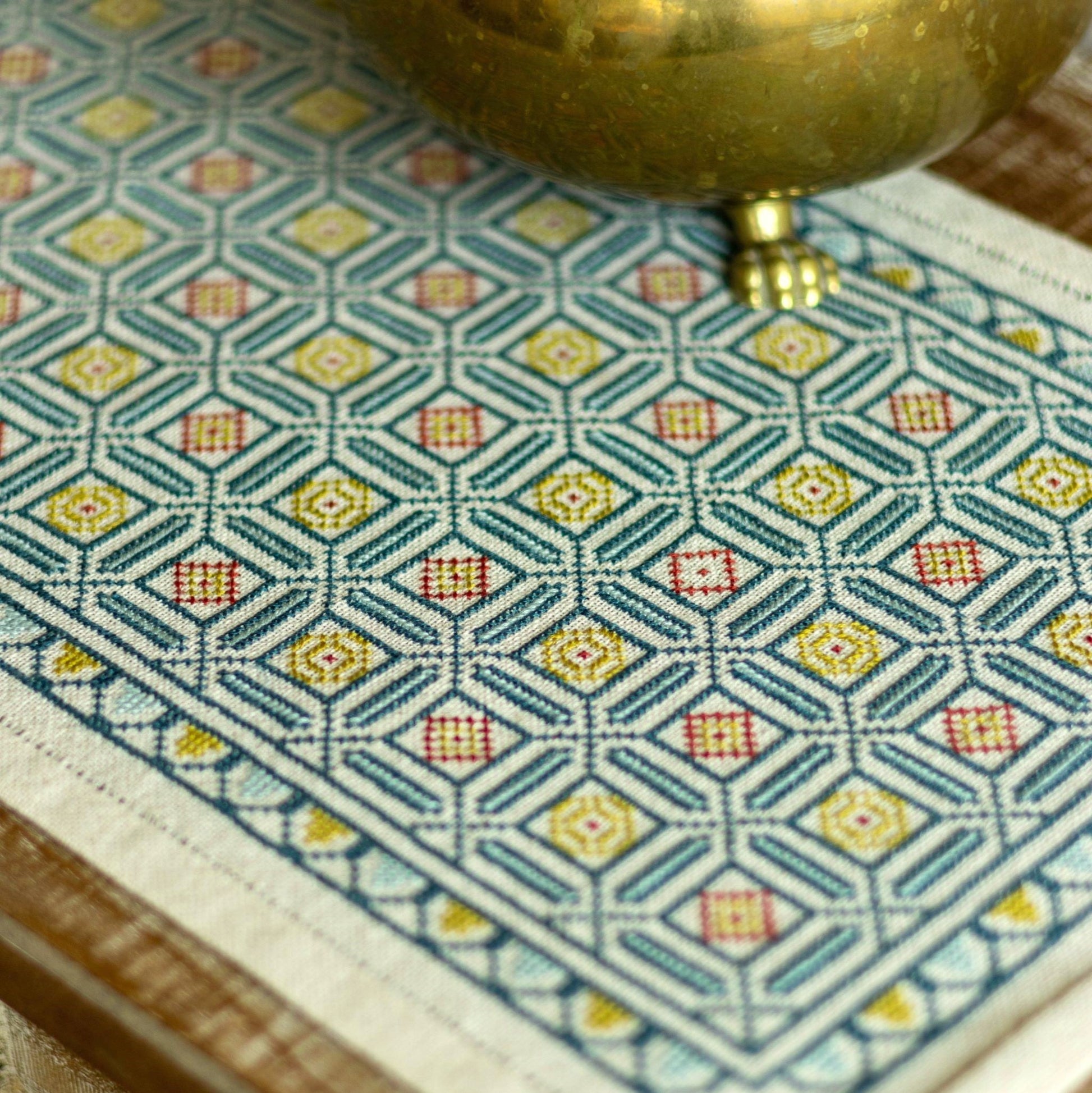 folk embroidery cross stitch with repeating tile design in blue