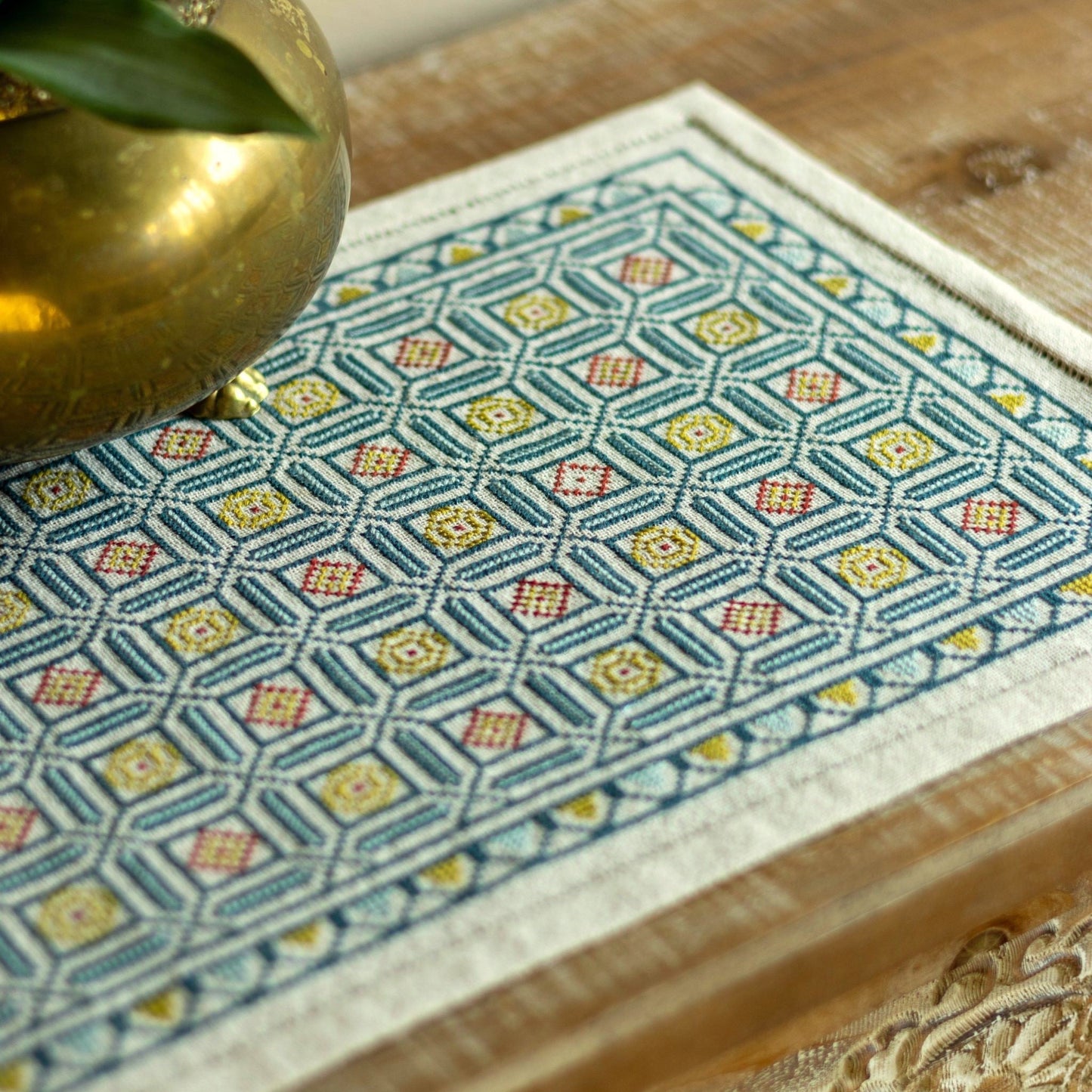 folk embroidery cross stitch with repeating mosaic tile design in blue and gold