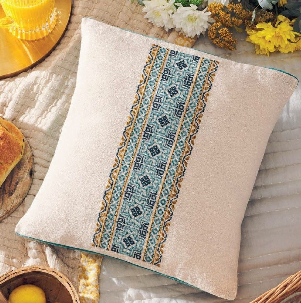 folk embroidery cushion with blue border design from everyday folk book