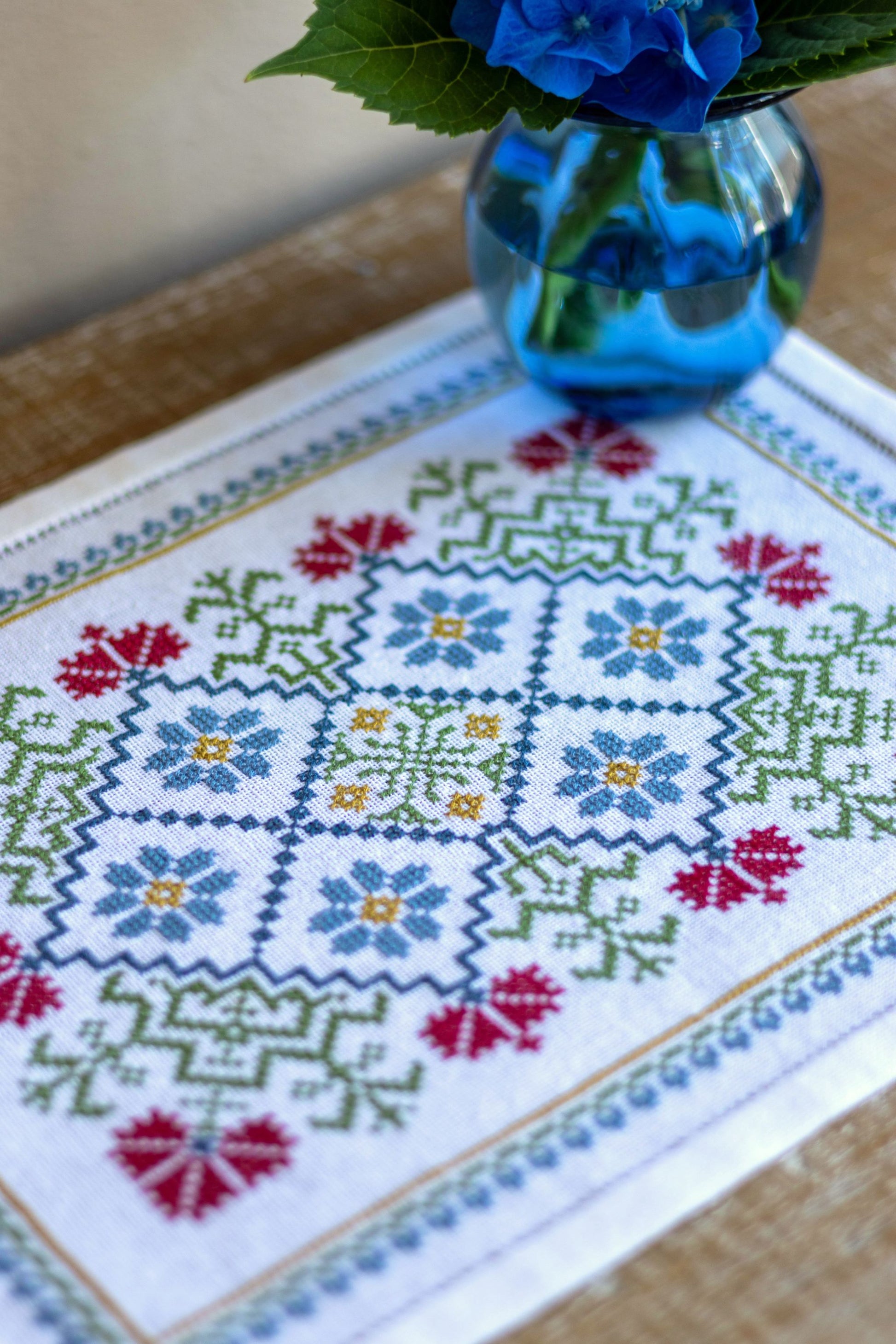 folk embroidery table mat with bright floral design