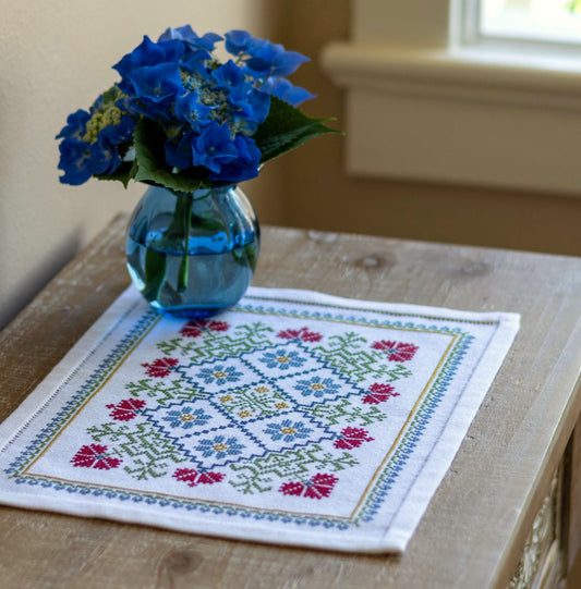 folk embroidery table mat with bright floral design