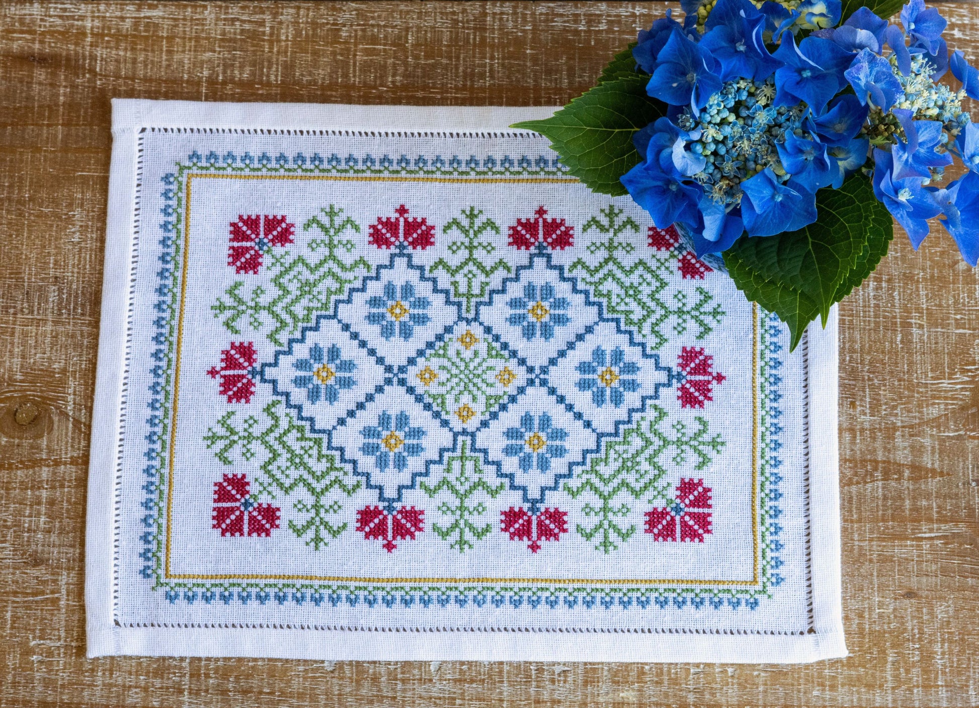 folk embroidery table mat with bright floral design