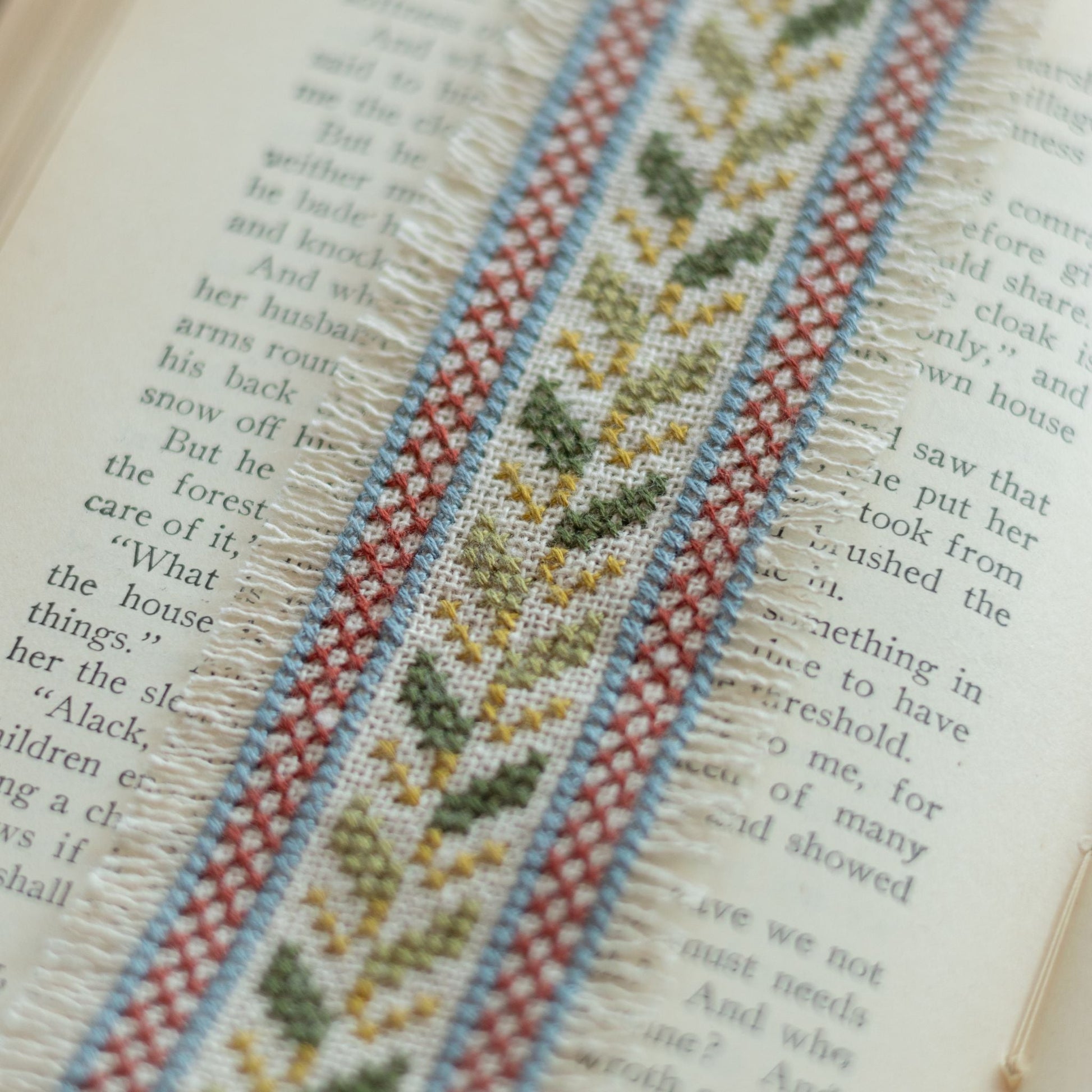 Embroidered ribbon with floral pattern on an open book
